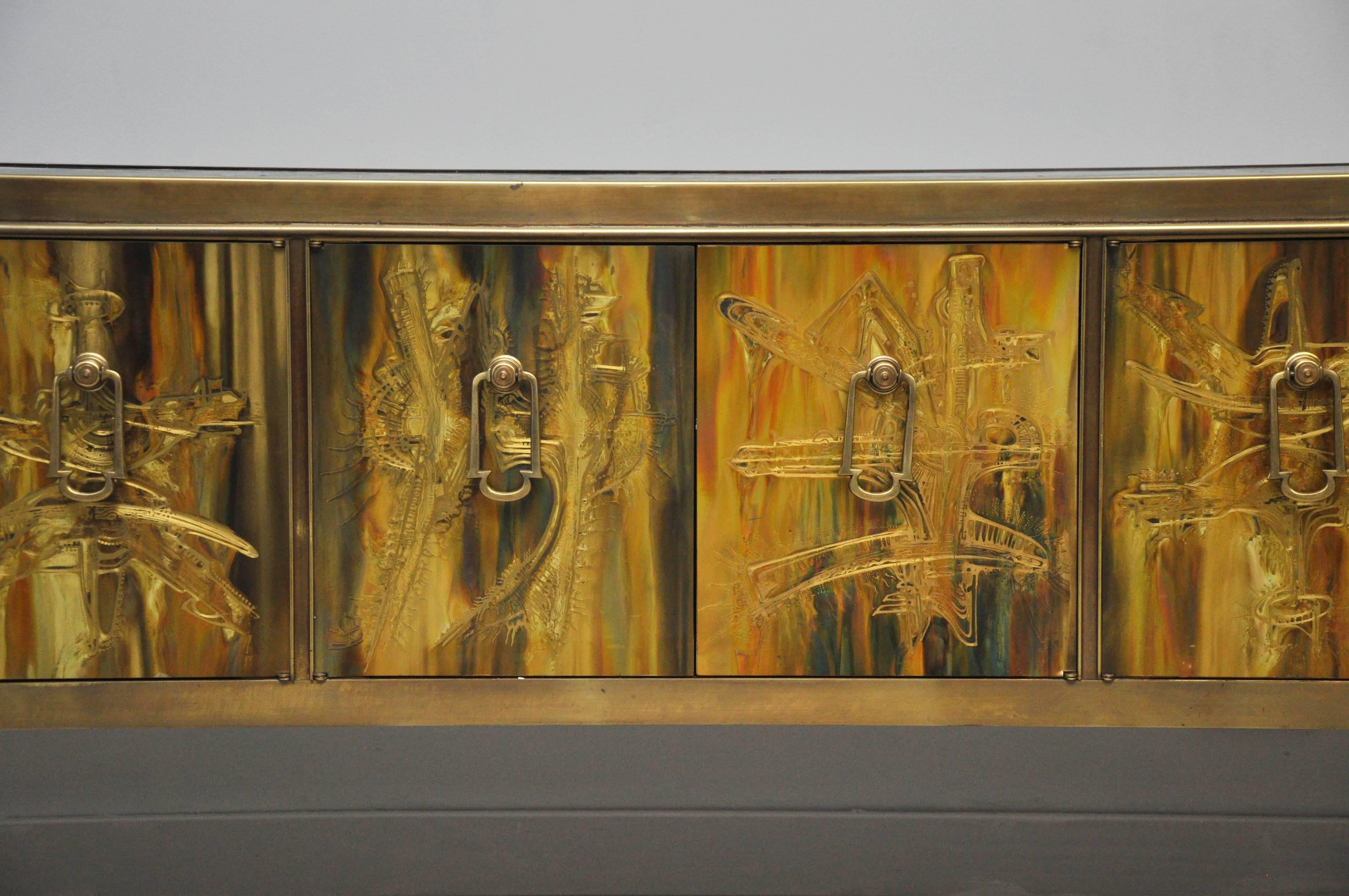 Brass credenza designed by Bernhard Rohne for Mastercraft. Brass panels were acid etched by Rohne to produce this magnificent piece of art. Doors open to a gold interior.