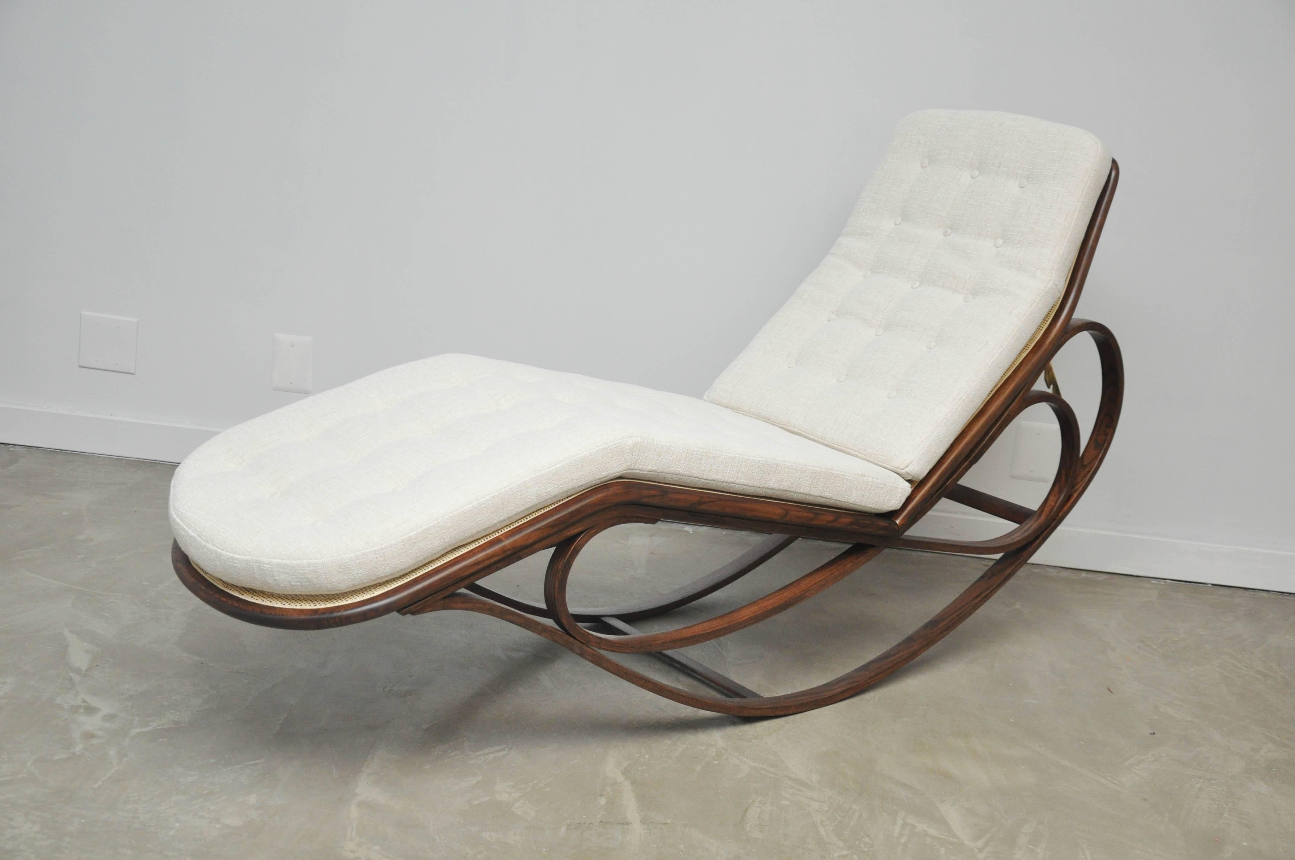 Adjustable rocking chaise with caned seat and back, espresso tone bent ash frame, brass details and newly upholstered cushion. Rare form designed by Edward Wormley for Dunbar.