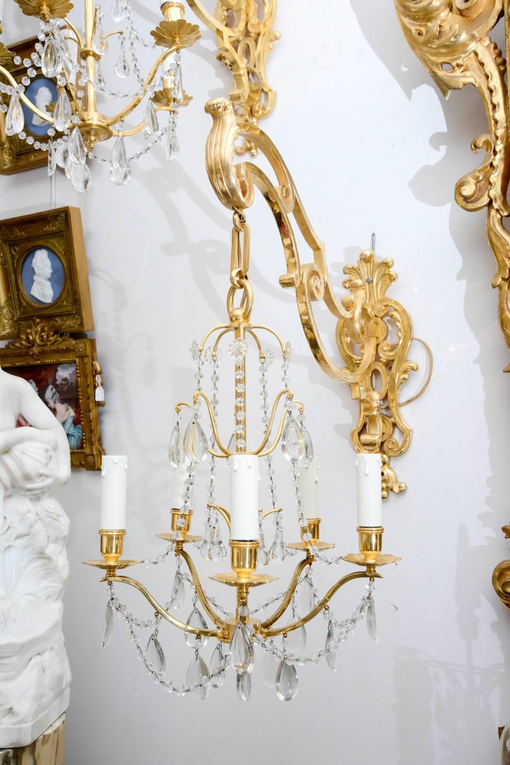 Two pairs of very rare and spectacular sconces, one arm of gilded bronze holding a chandelier in crystal and bronze, five lights.