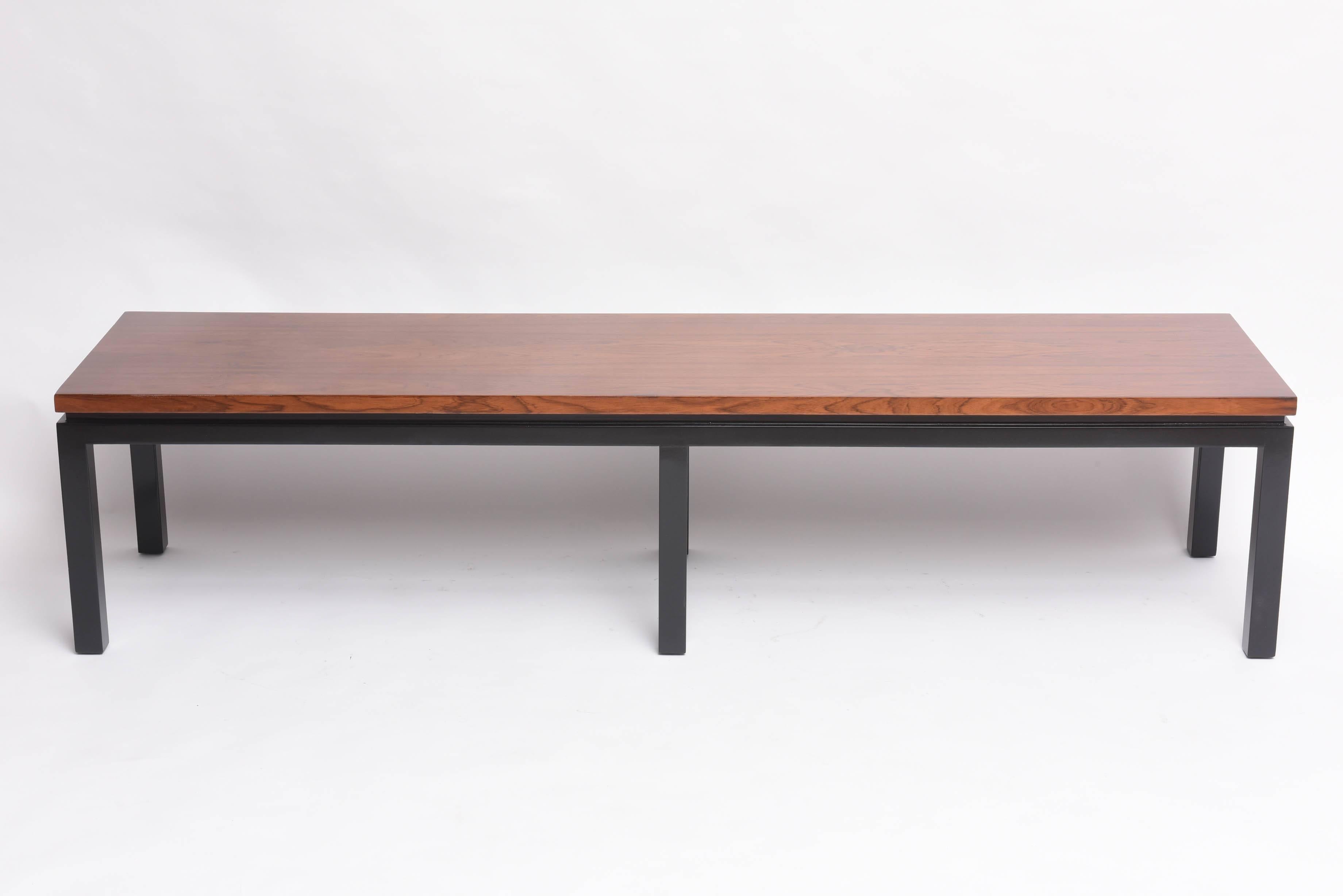 This beautiful Mid-Century piece dates to the late 1940s-1950s. The base is finished in black and the top is walnut and with its clean lines this piece can be used as a bench at the end of the bed, hallway or as a cocktail table. 


