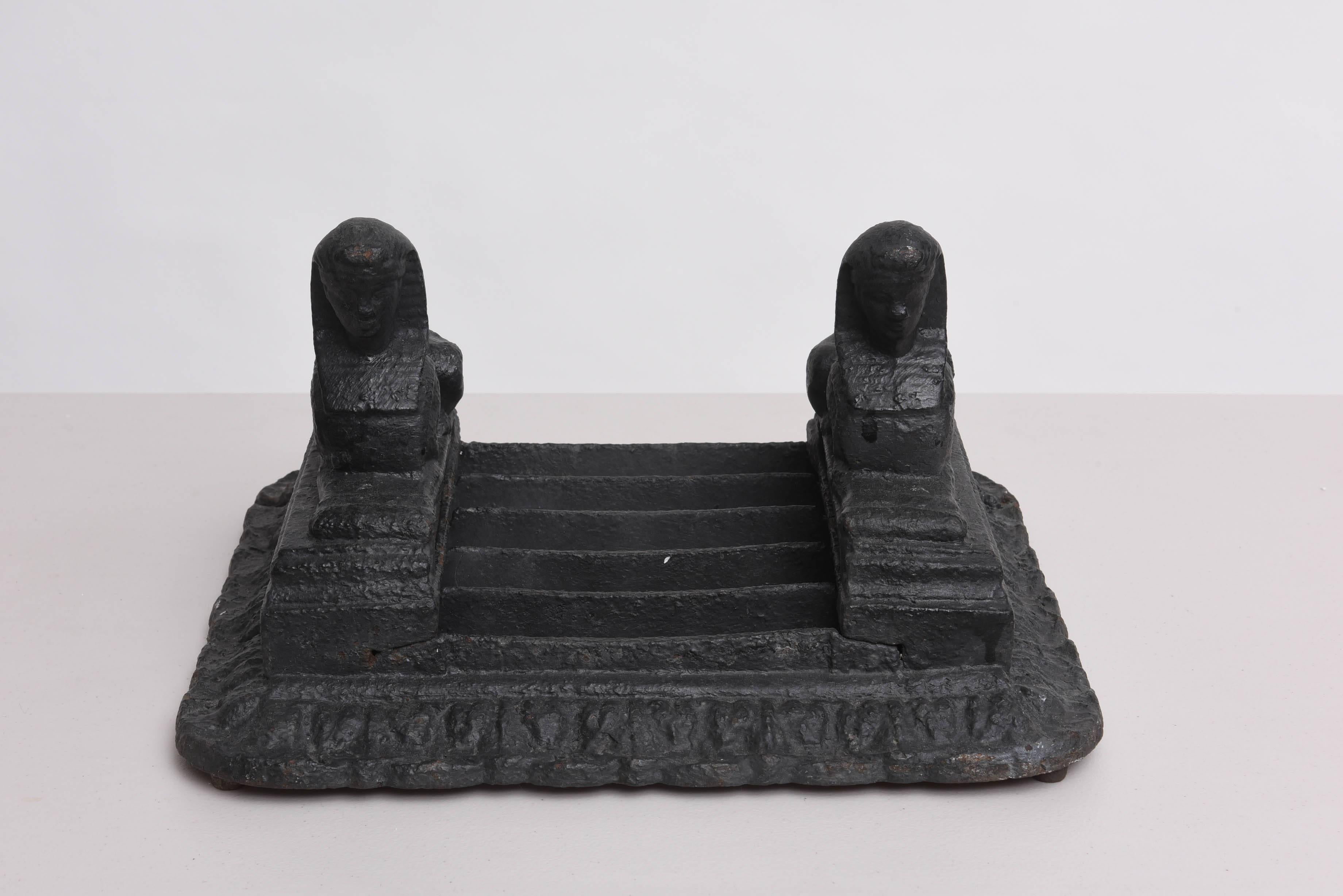 This rare early 19th century boot-scraper was created by the firm of Archibald Kenrick & Sons in England during the height of Napoleons reign in France. They are made of cast-iron and are in the Egyptian taste with a pair of flanking sphinxes