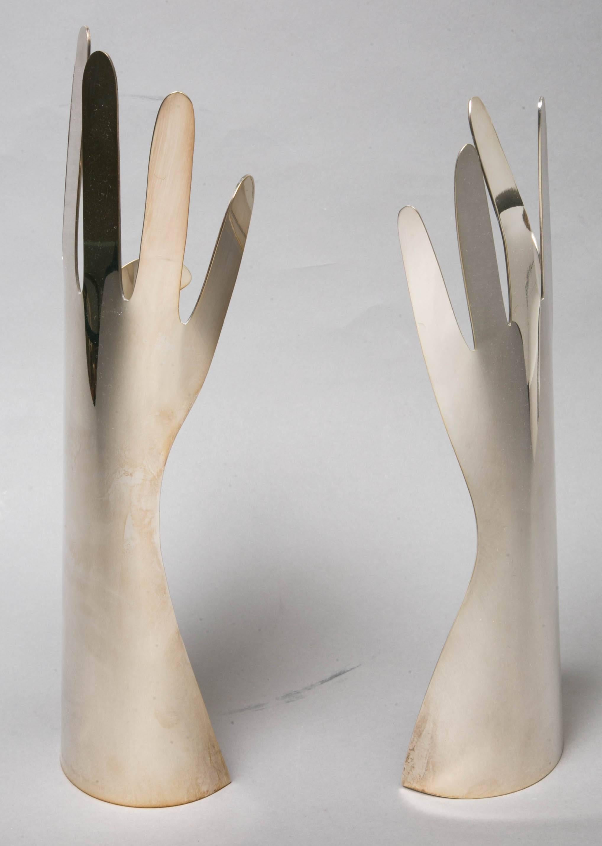 Two silvered metal hands by Gio Ponti (1891-1979) for L. Sabattini, 1978, Italy.
Left hand, and right hand with 6 fingers . 
Signed: Sabattini Italy-design Gio Ponti, 1978.
Dimensions : Height 32 and 35 cm. 

Refined objects as results of the