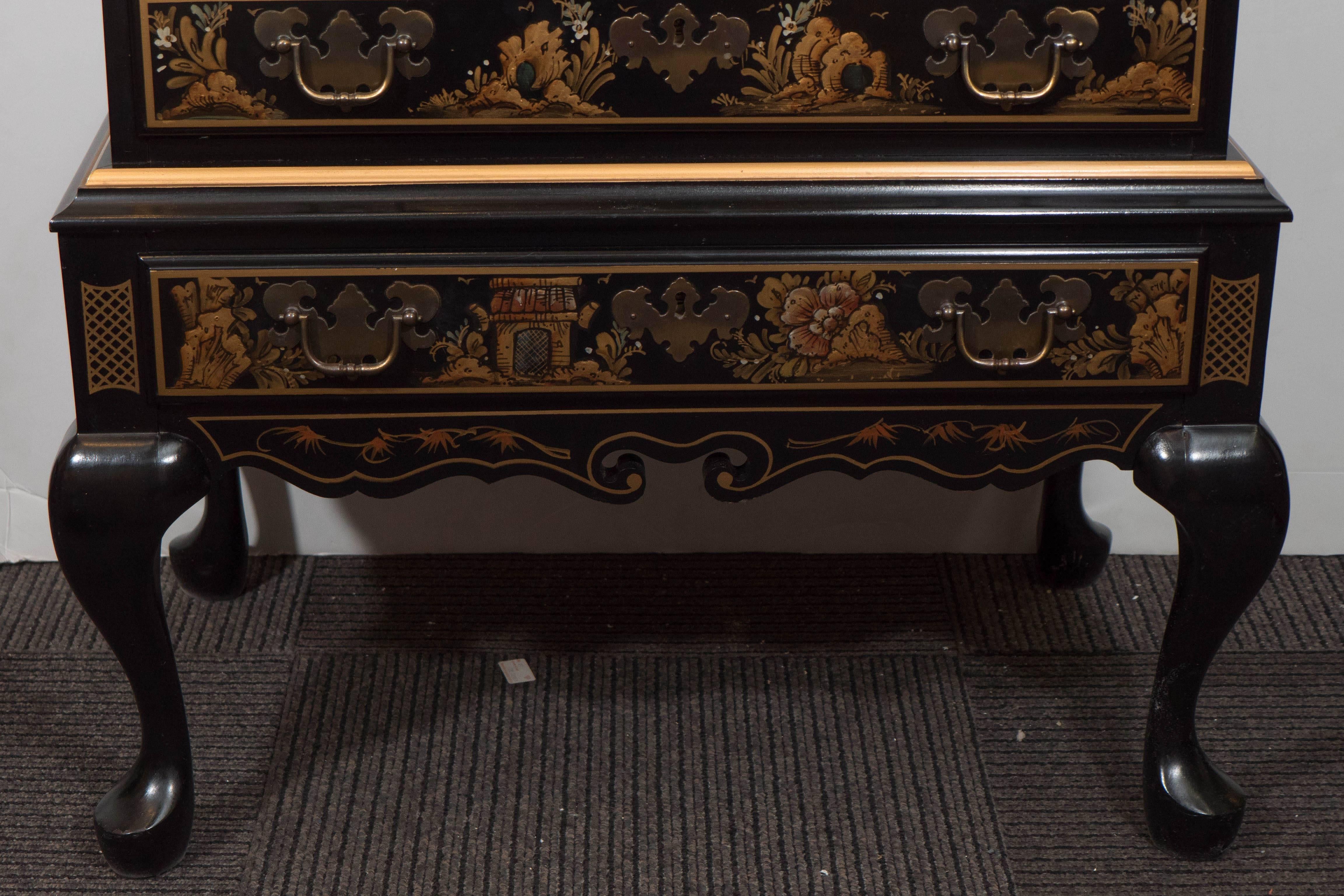 A vintage secretaire desk in black lacquer by Maddox Furniture, designed in the chinoiserie mode, and hand-painted with Asian Motifs. An ornately decorated drop-front (Key provided) with extending lopers, opens to reveal a writing space with five
