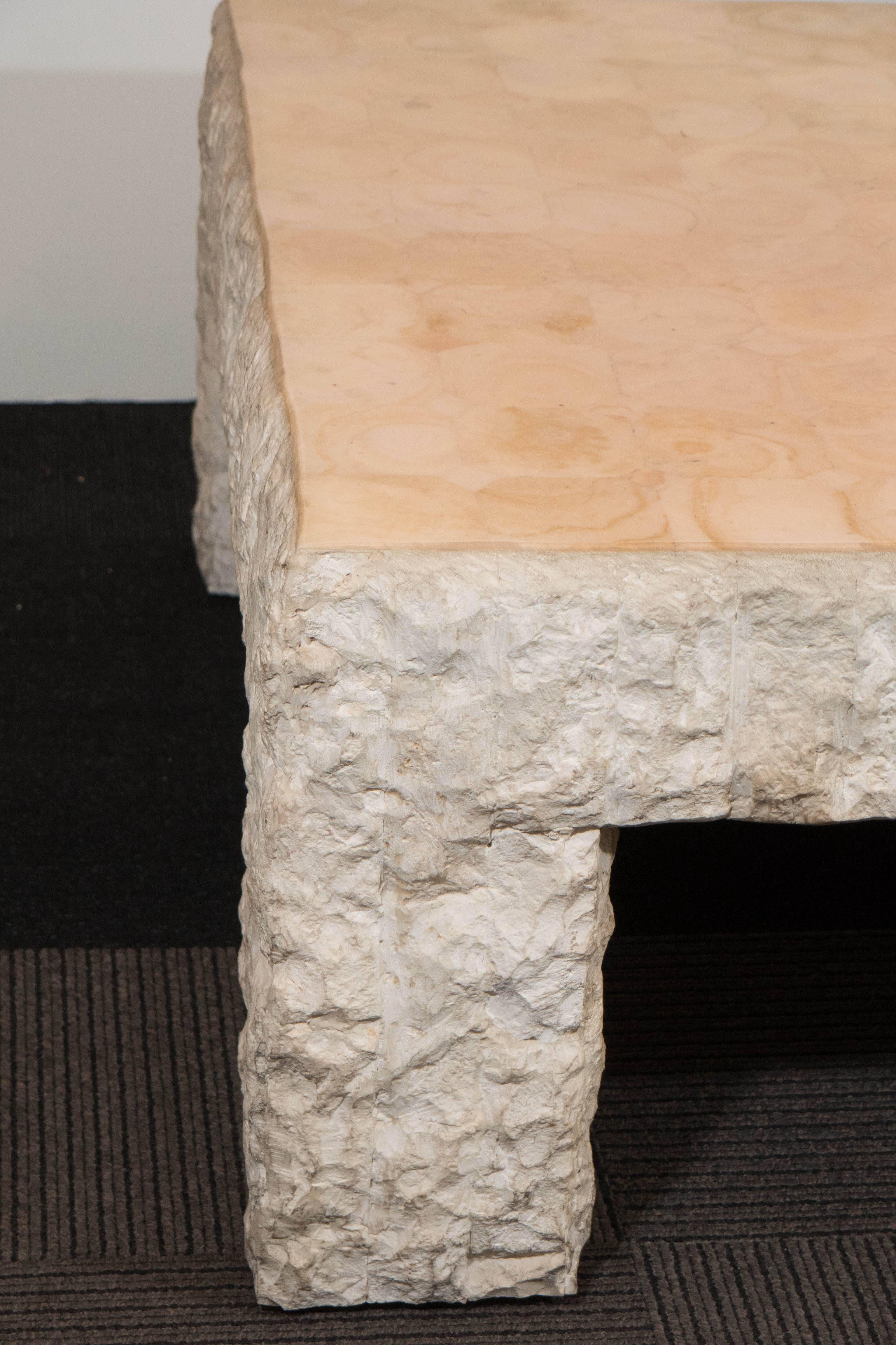 A vintage coffee and cocktail table, produced circa 1970s by Maitland-Smith, entirely in travertine stone, the polished top a unique contrast with the rough, surrounding body. Markings include manufacturer's label to the bottom. Very good condition,