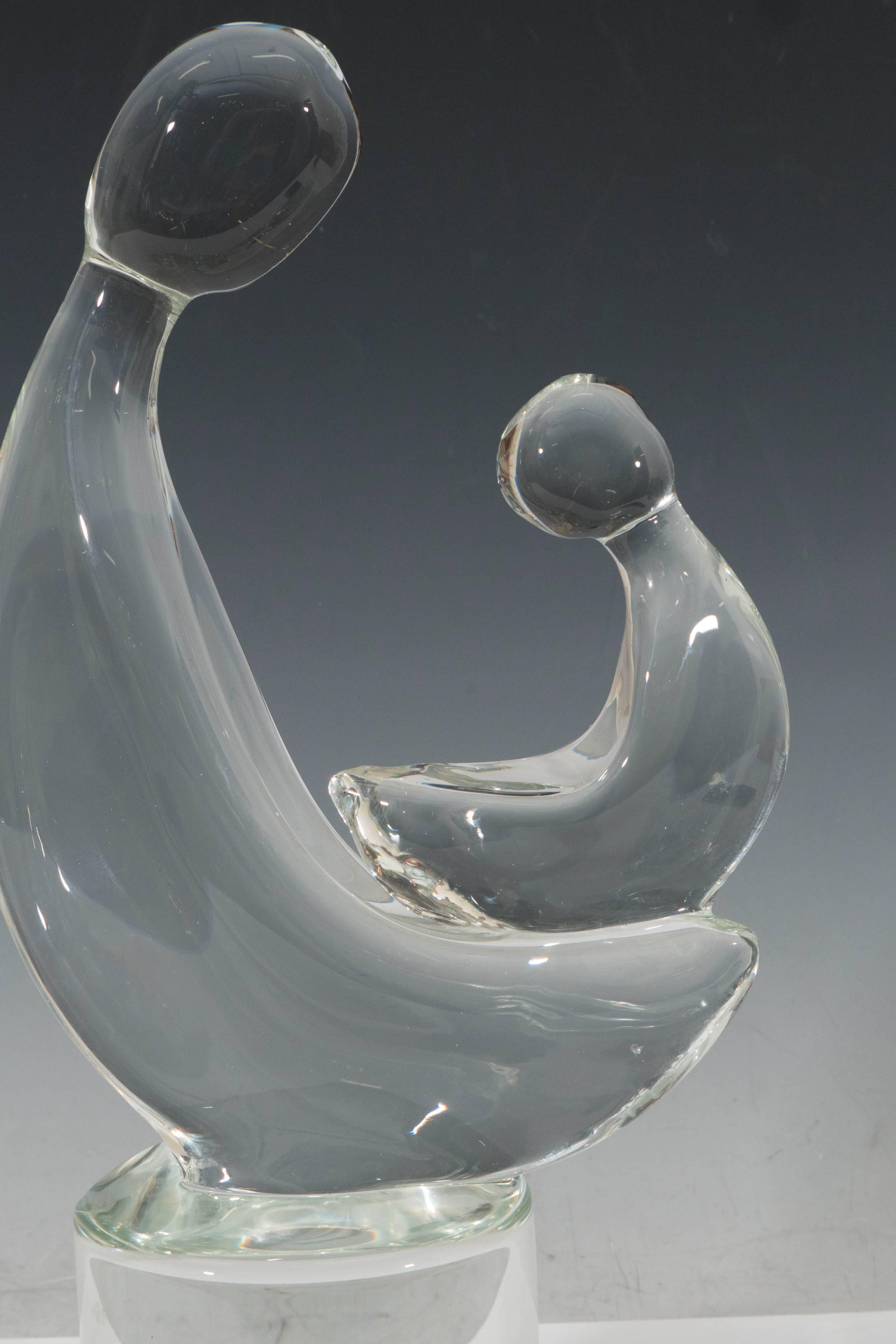 A vintage glass sculpture, created, circa 1980s by Murano glass artist Licio Zanetti, which depicts a modern abstract take on the iconic representation of a mother and her child. Markings include artist's signature, to the underside of the base.