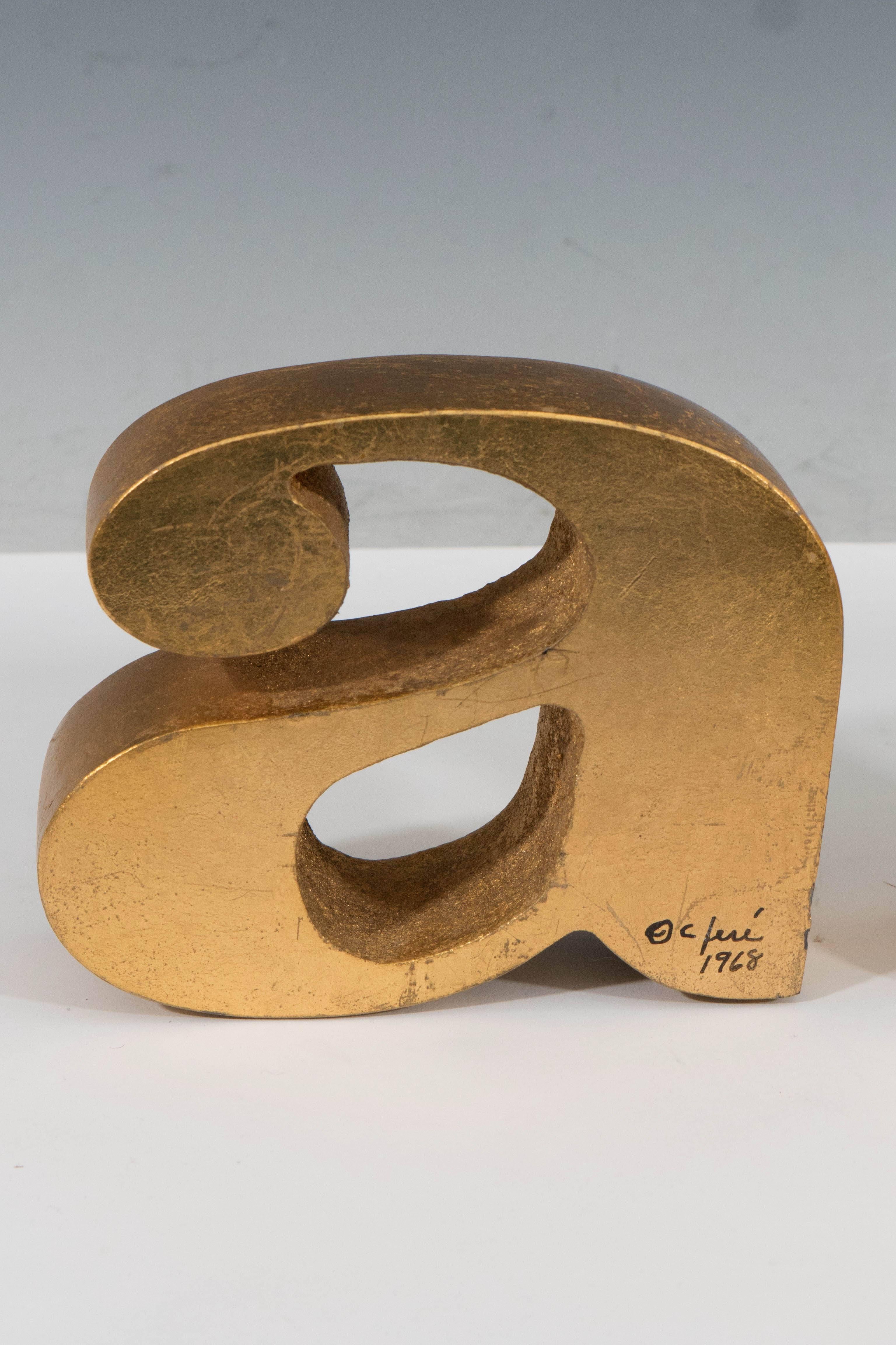 A pair of vintage sculptural bookends by Curtis Jere, in the form of lowercase letters 'a' and 'z', each in metal, with brilliant gold gilding. Markings include signature [C. Jere/1968], signed to the bottom right sides of both pieces. The bookends