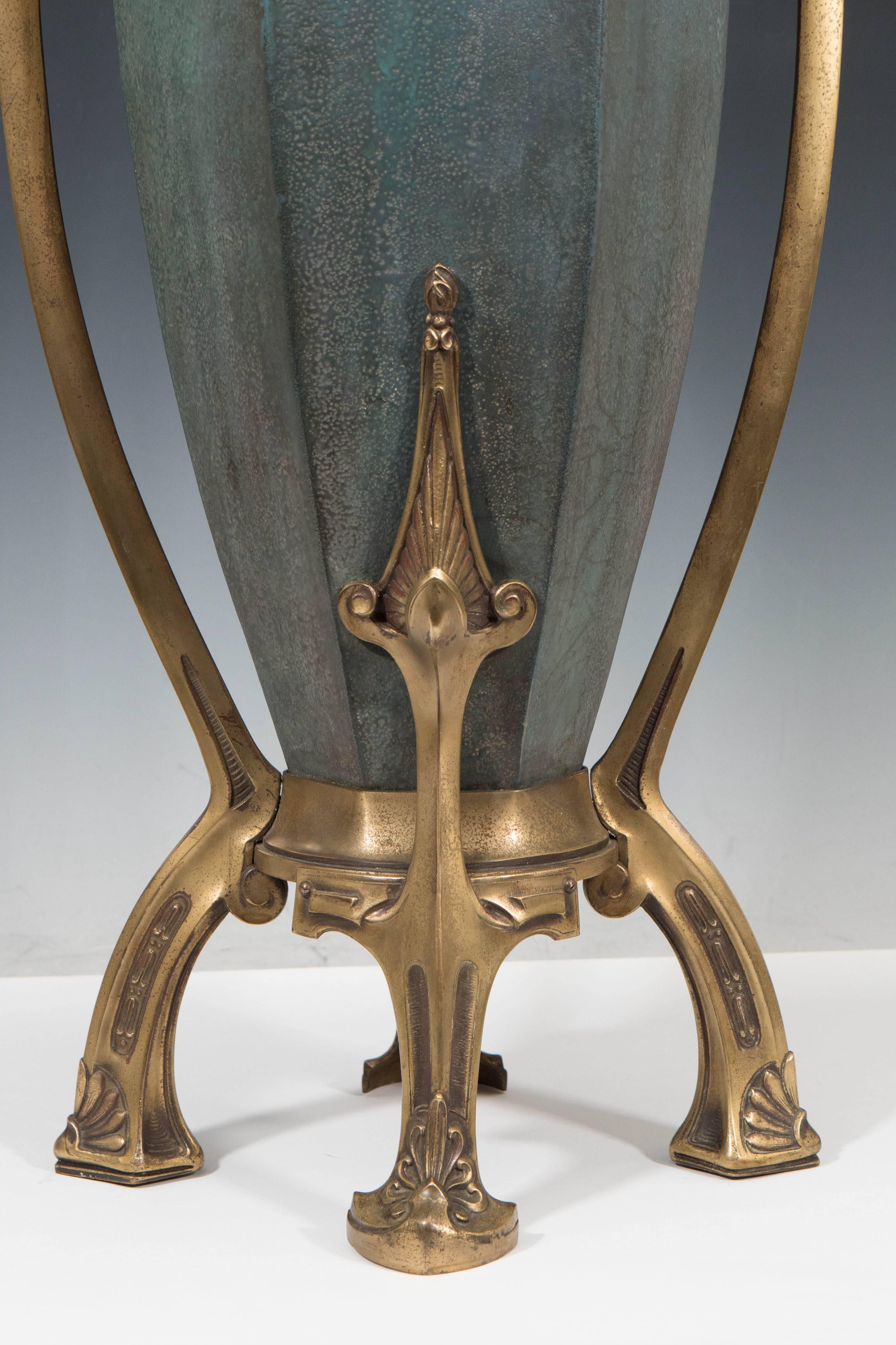 This ceramic Amphora vase with matte finish and elaborate bronze mounting was produced circa 1900s by Paul Dachsel. The flowing shape of the raised bronze handles and artfully applied details to this exhibition piece make it a stunning example of