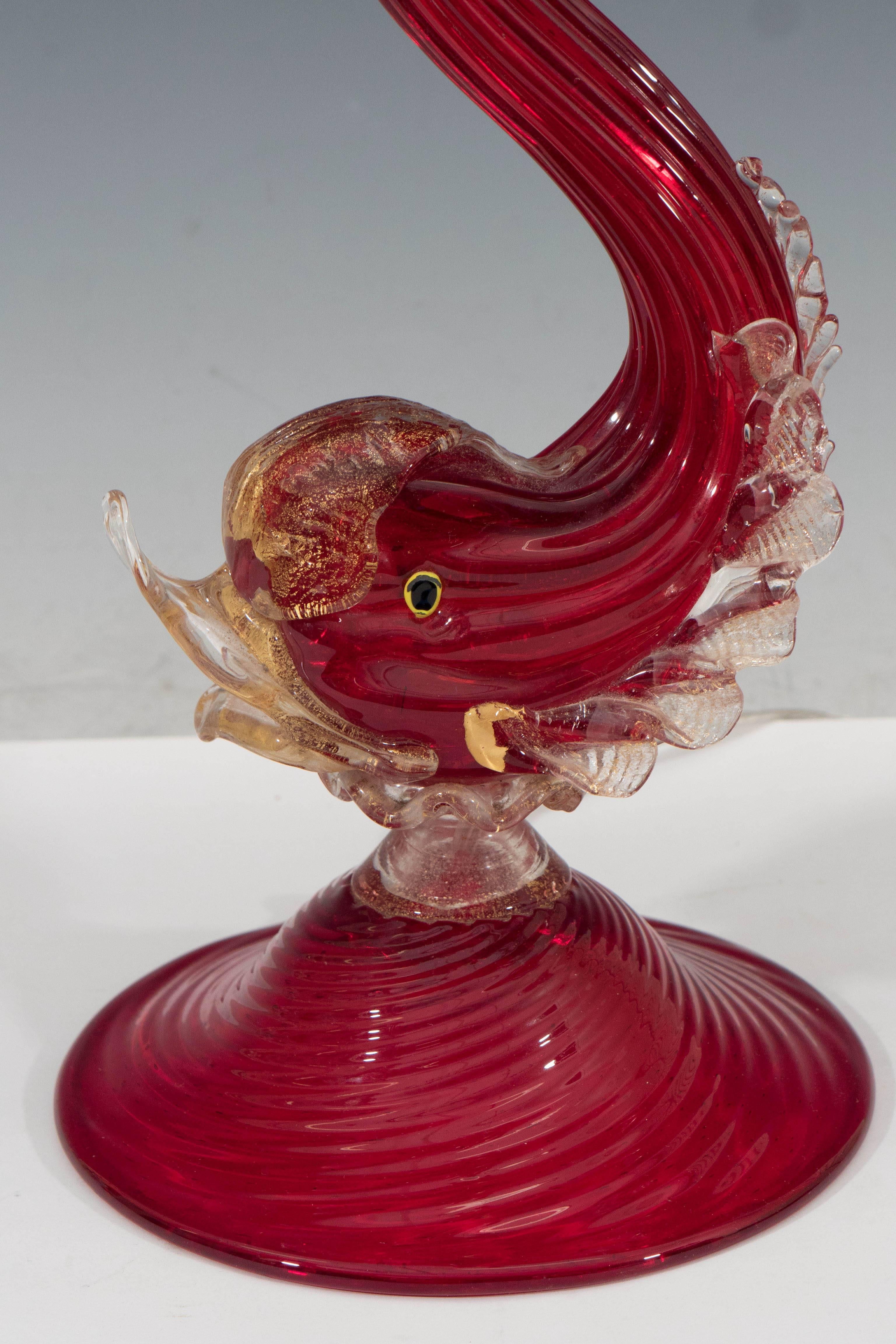 A Hollywood Regency style table lamp in Murano glass, attributed to Barovier e Toso and produced circa 1940s. The lamp is designed as a red glass fish with applied clear polvere o’oro glass fins, lips and tail. The company of Barovier e Toso was