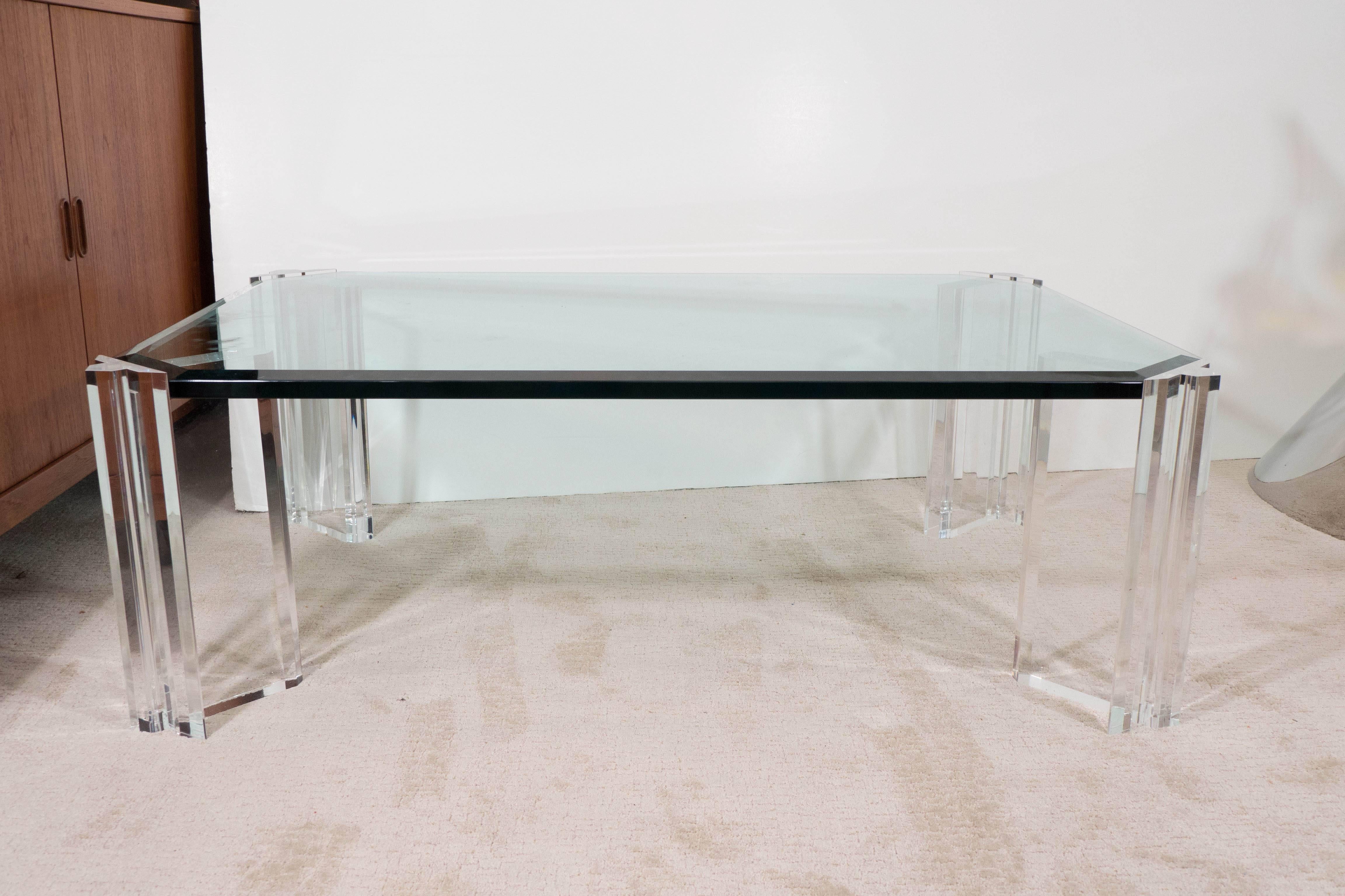 This coffee and cocktail table comes with a thick beveled glass top, above modernistic, beautifully clear, supporting Lucite legs. Overall very good condition, any present wear to the Lucite consistent with age and use.