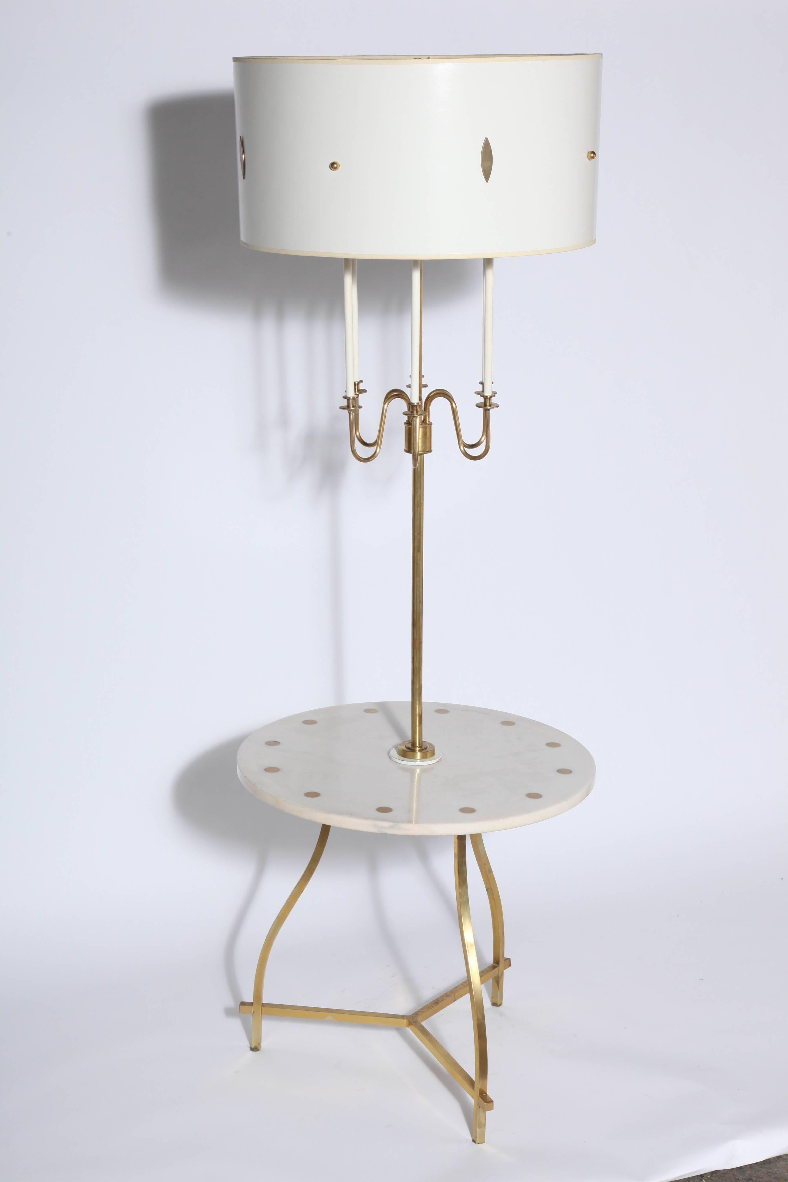 Tommi Parzinger style White and Brass Tiered Candlestick Floor Lamp with Marble Side Table.  Featuring a Brass tripod leg framework, round 22.5D White Marble Side Table, round Brass button inlay, six Brass candlesticks, White enamel candle style