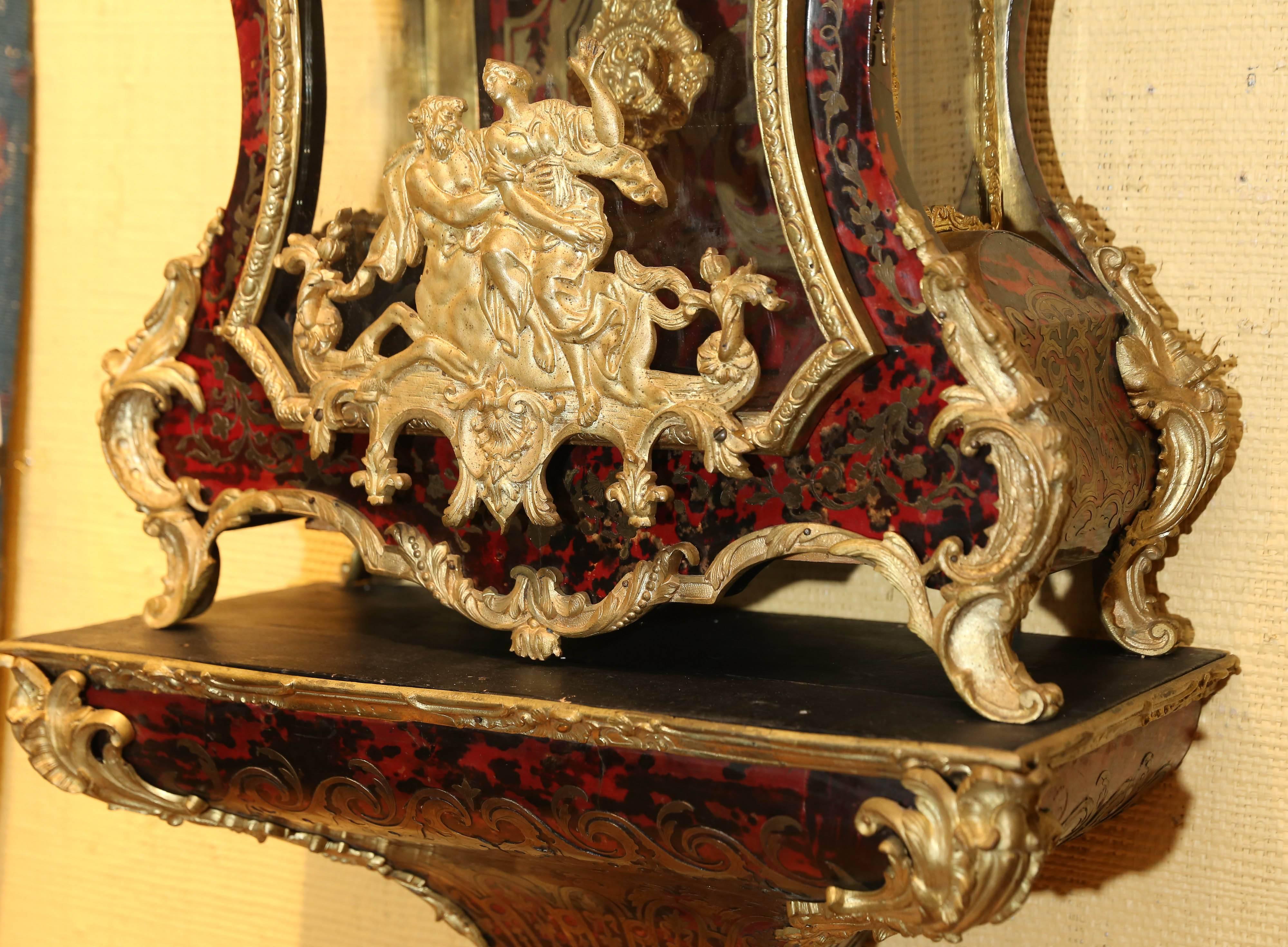 Large Louis XV bracket clock with the trumpet blowing
Archangel Gabriel above boulle style and brass decorated case
The front glass door is faced with a brass mythological scene.
It opens to a clock face marked Balthazard, Paris