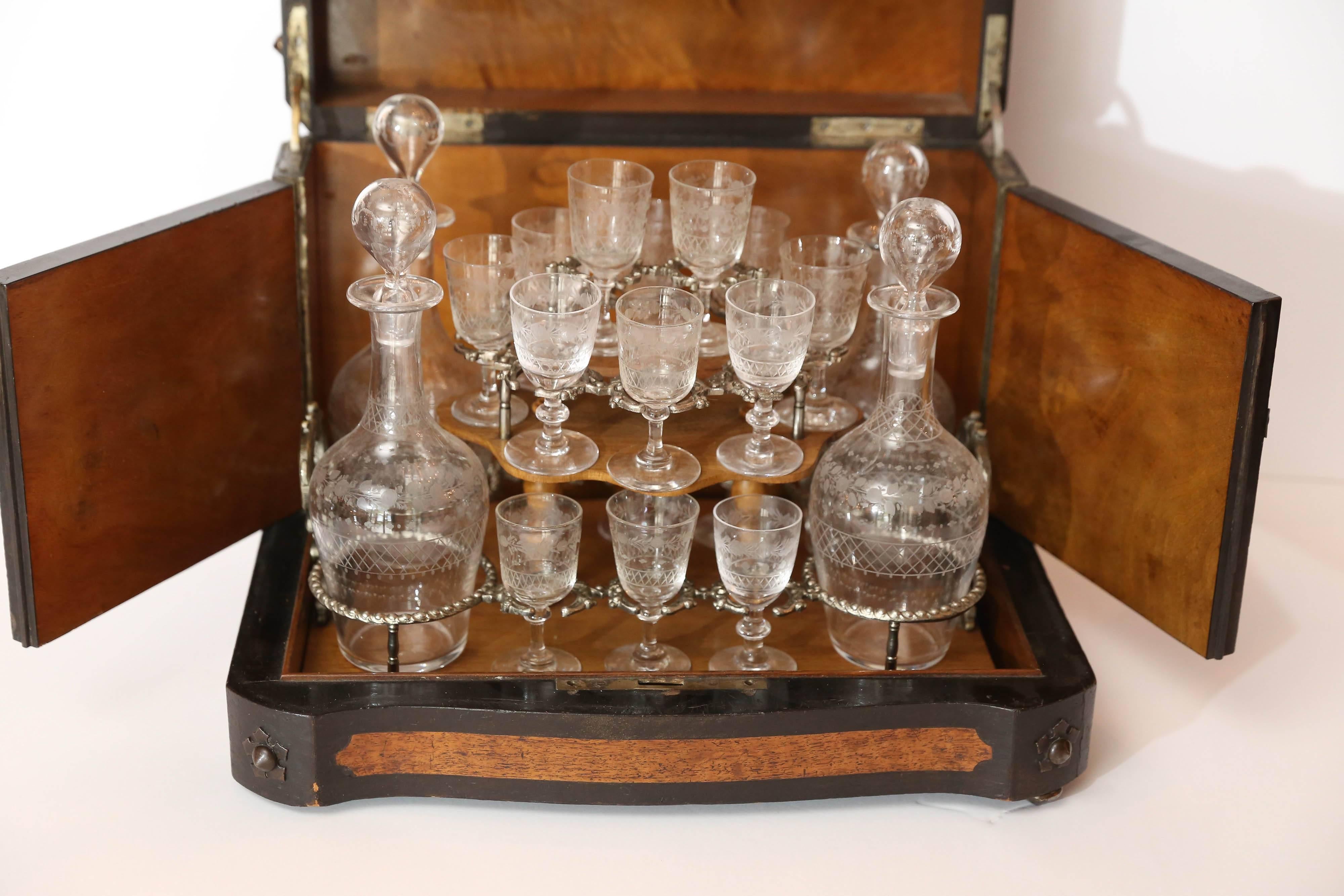 Handsome French Cave de Liqueur set.
Pewter nailheads and decorations to case.
Ebonized banding on a lighter wood case.
16 glasses that are beautifully etched and handblown.
Four bottles that are original.
All sit on a lift out tray.