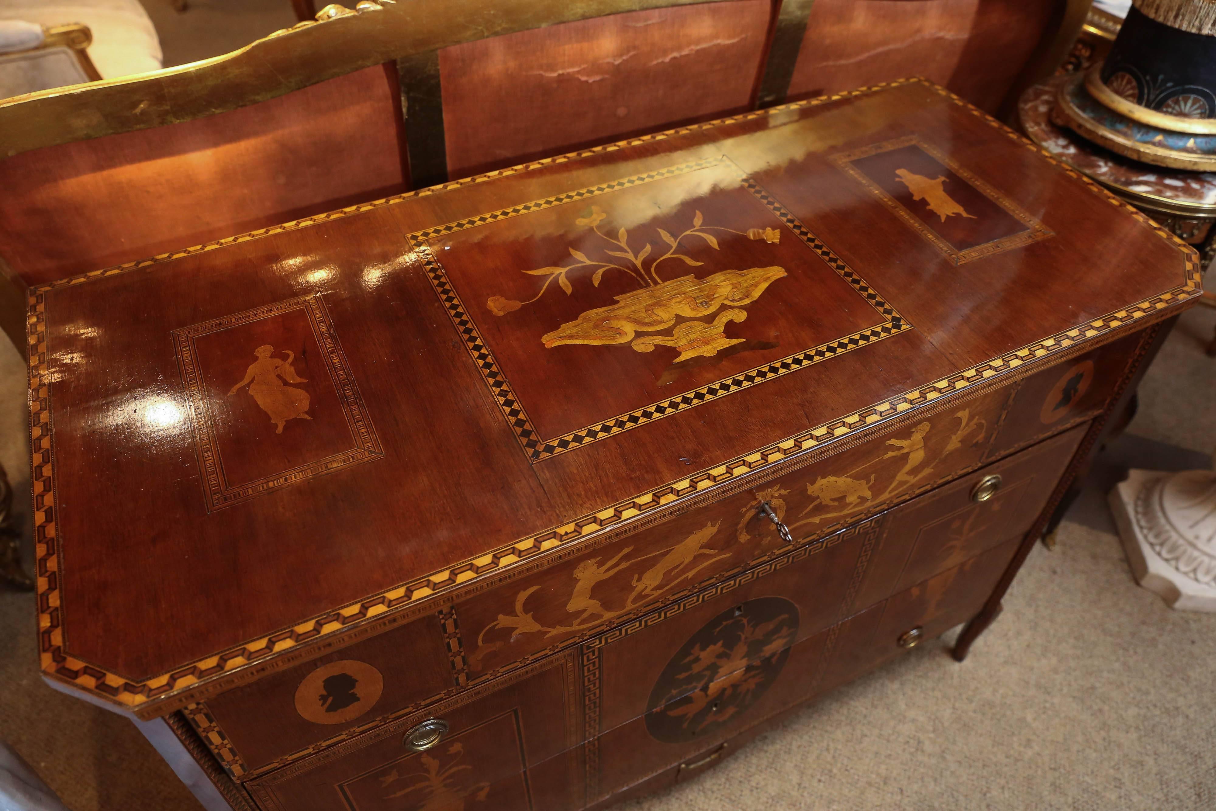 Rectangular top with canted corners, fitted with long drawers
with figural, foliate and marquetry inlay, raised on cabriole legs.
Very fine and intricate inlay on all sides and top.
 