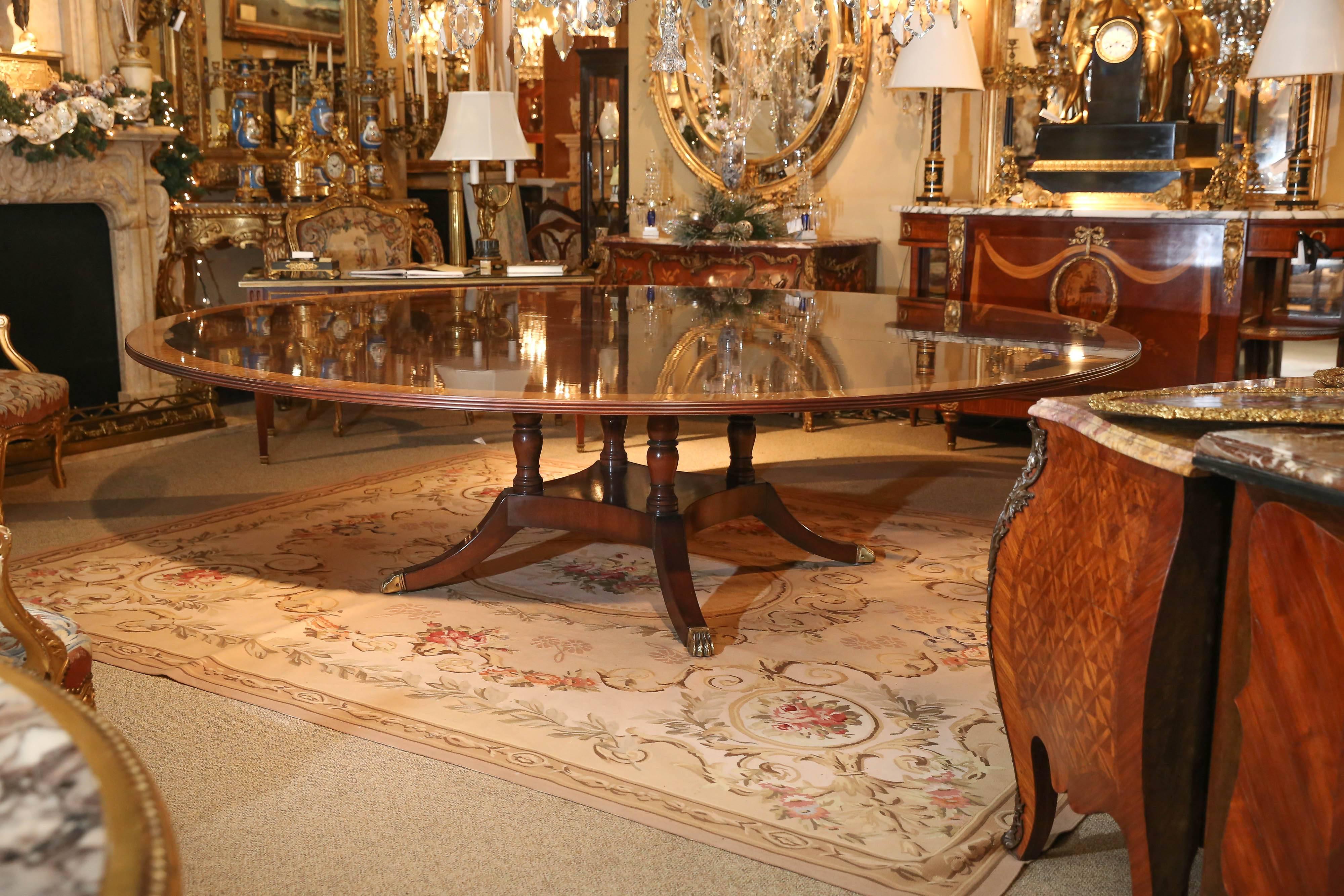 Large mahogany round dining table banded in satinwood
The diameter is 108 inches
It was made by the Kittinger Company