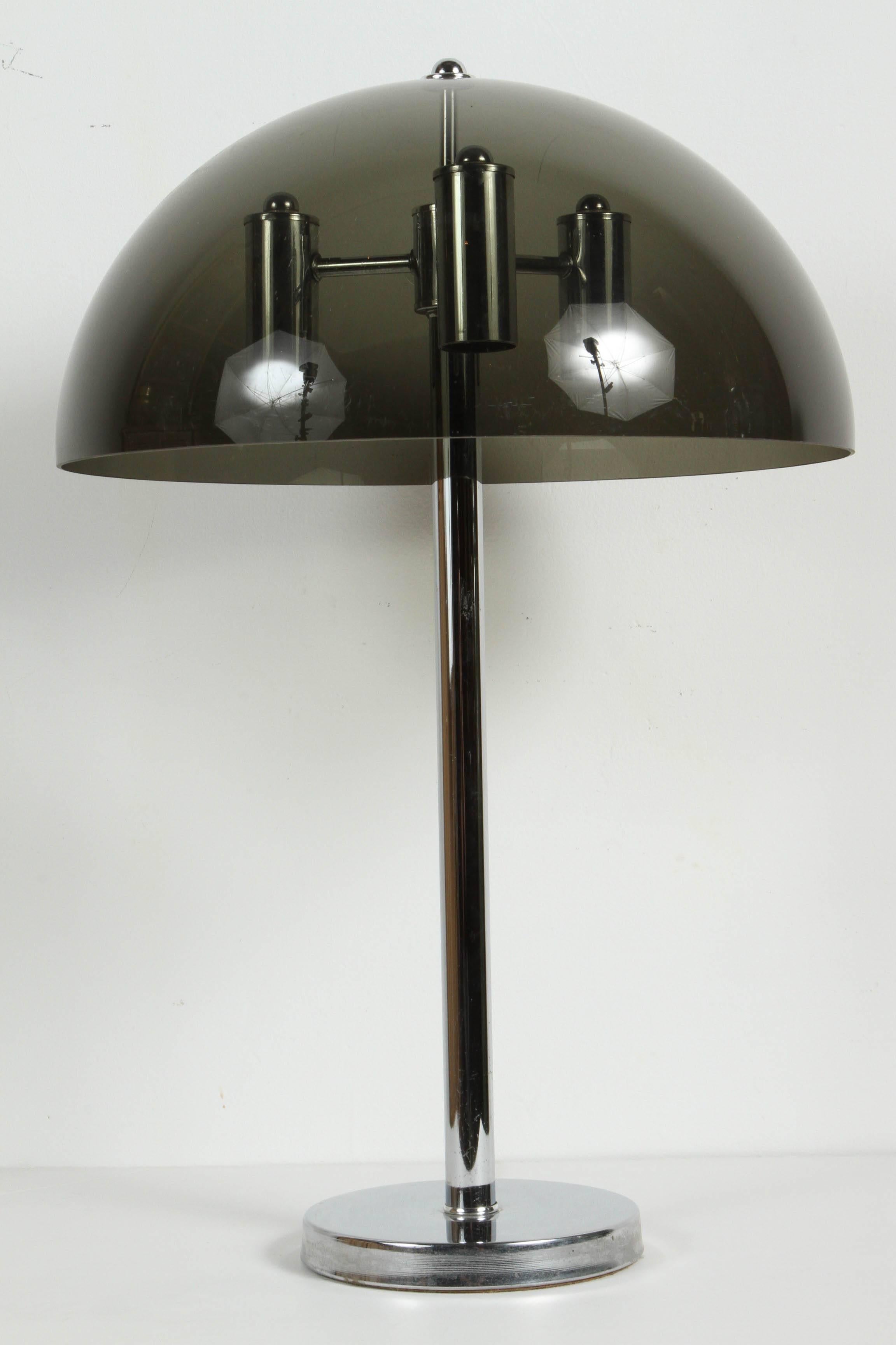 Smoked Lucite dome shade desk lamp mounted on a thin chrome column, with a circular base.
Mushroom, Sputnik style table desk lamp, circa 1970.
Measures: Overall height 24 in, diameter of shade 16 in, height of shade 8 in.
Base measures 7 in