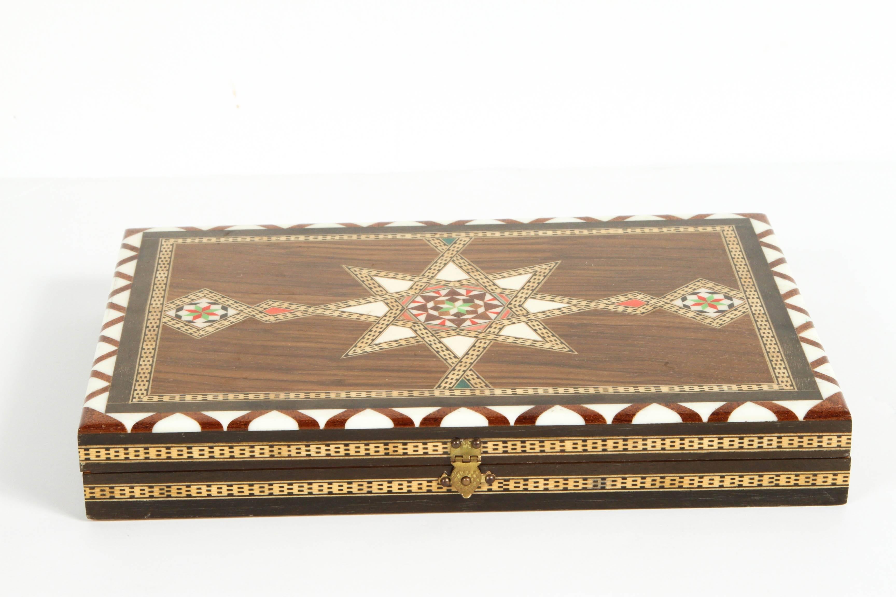 Middle Eastern Syrian inlaid mosaic backgammon game.
Great handcrafted inlaid  mosaic box with backgammon game with all the wooden dice and pieces.
 Size: Closed: 10