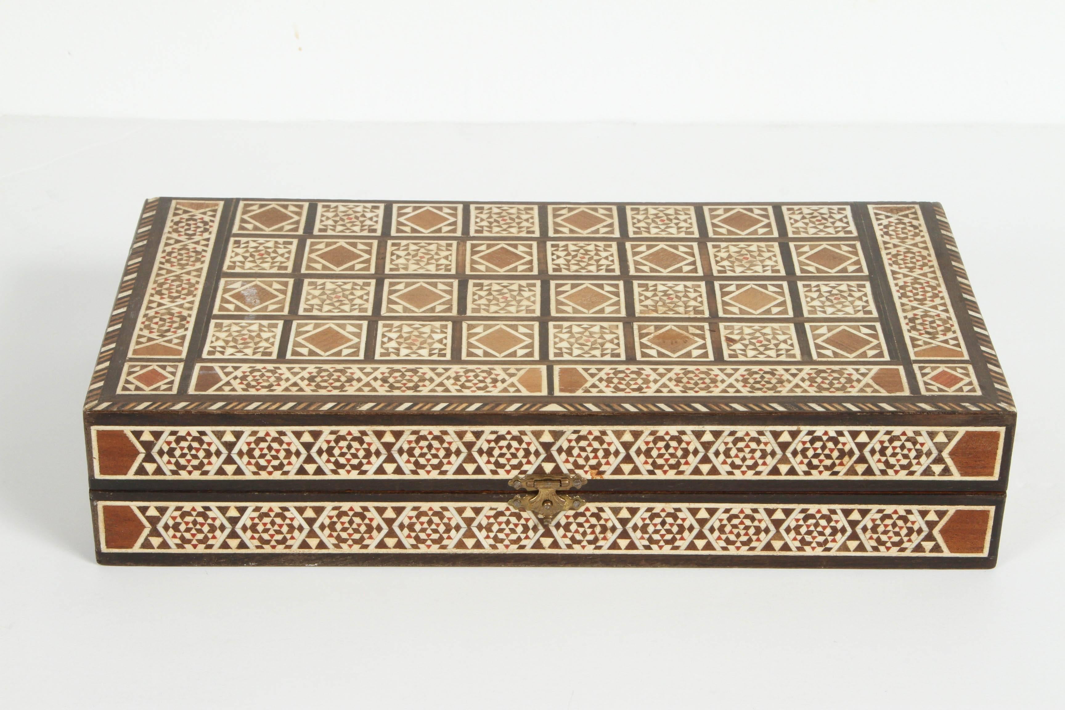Syrian inlaid mosaic backgammon game.
Great hand-crafted Middle Eastern inlaid micro mosaic box with backgammon game with all dice and pieces.
Size: Closed: 12