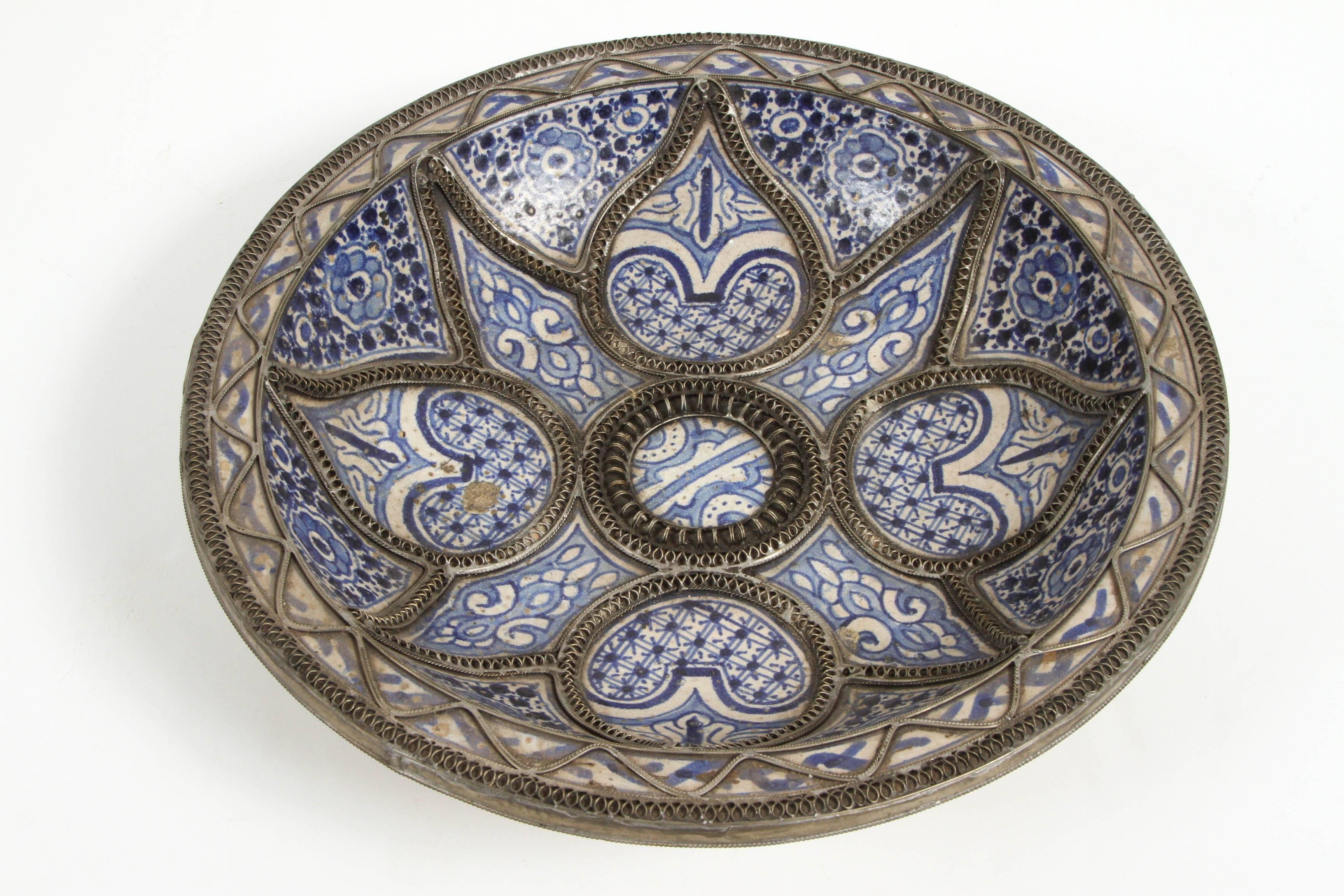 Hand-crafted set of three Moroccan decorative ceramic plates from Fez, Morocco..
Hand-painted in polychrome and Bleu de Fez colors, very nice designs. hand-made by artist in Fez with geometrical and floral designs and adorned with nickel silver