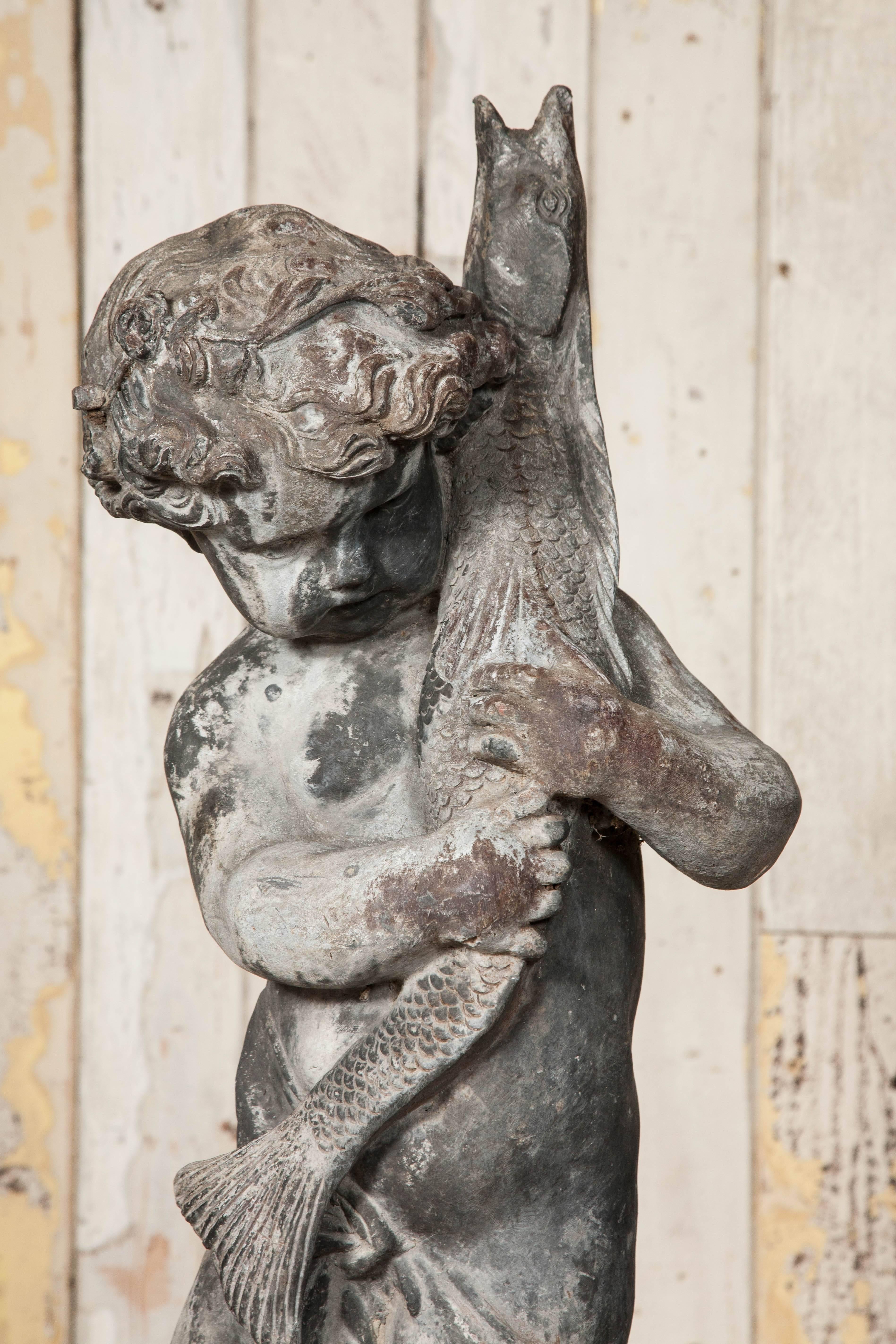 An original antique lead fountain made by the prominent casters H Crowther. The boy with pike is a copy of a work by 15th century Italian sculptor Verrocchio. 