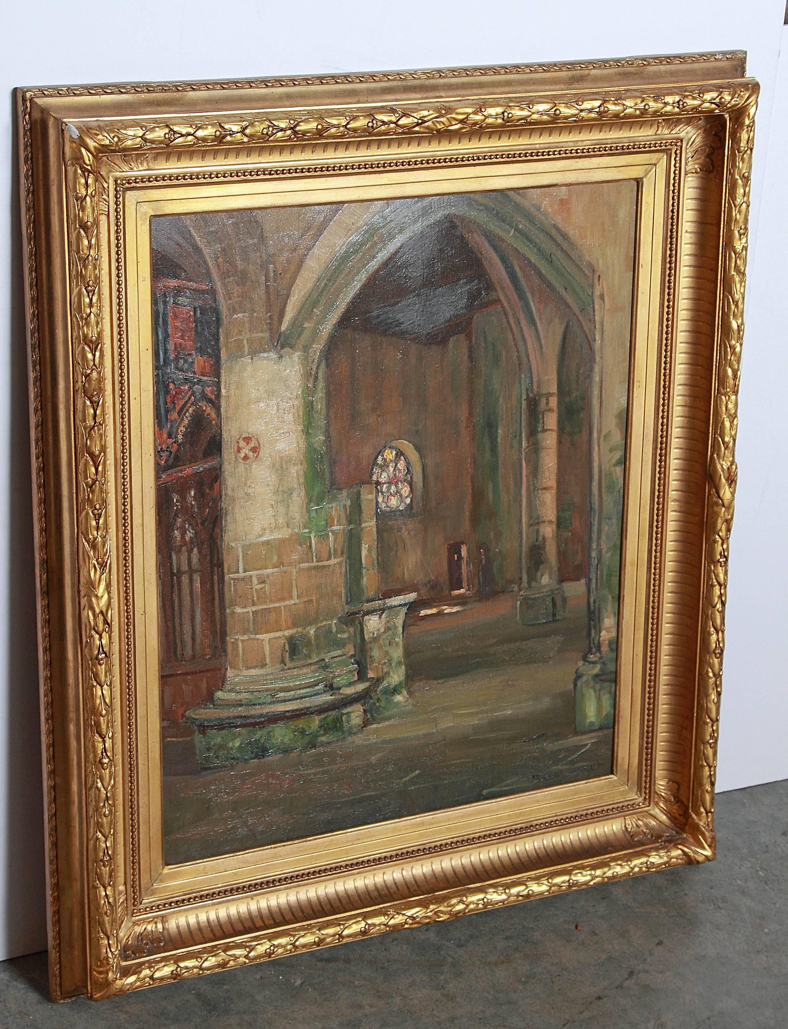 This serene oil painting on board depicts the beautiful Gothic interior of a French church.  It has been signed by Marcel Canet (1875-1959) in the lower right hand corner.  The beautiful giltwood frame has motifs of laurel leaves and berries with
