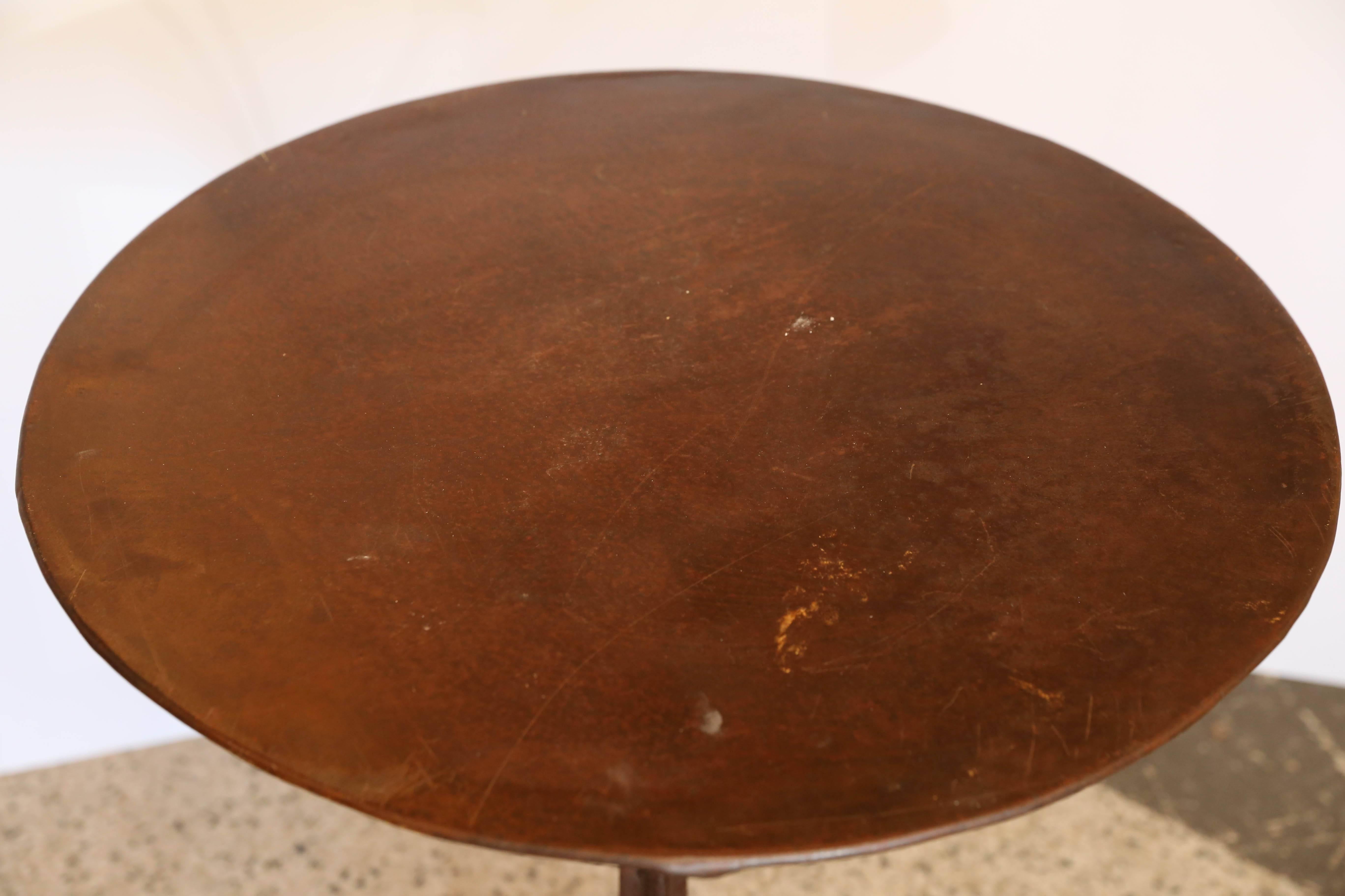 Iron base and metal top bistro table, marked with 