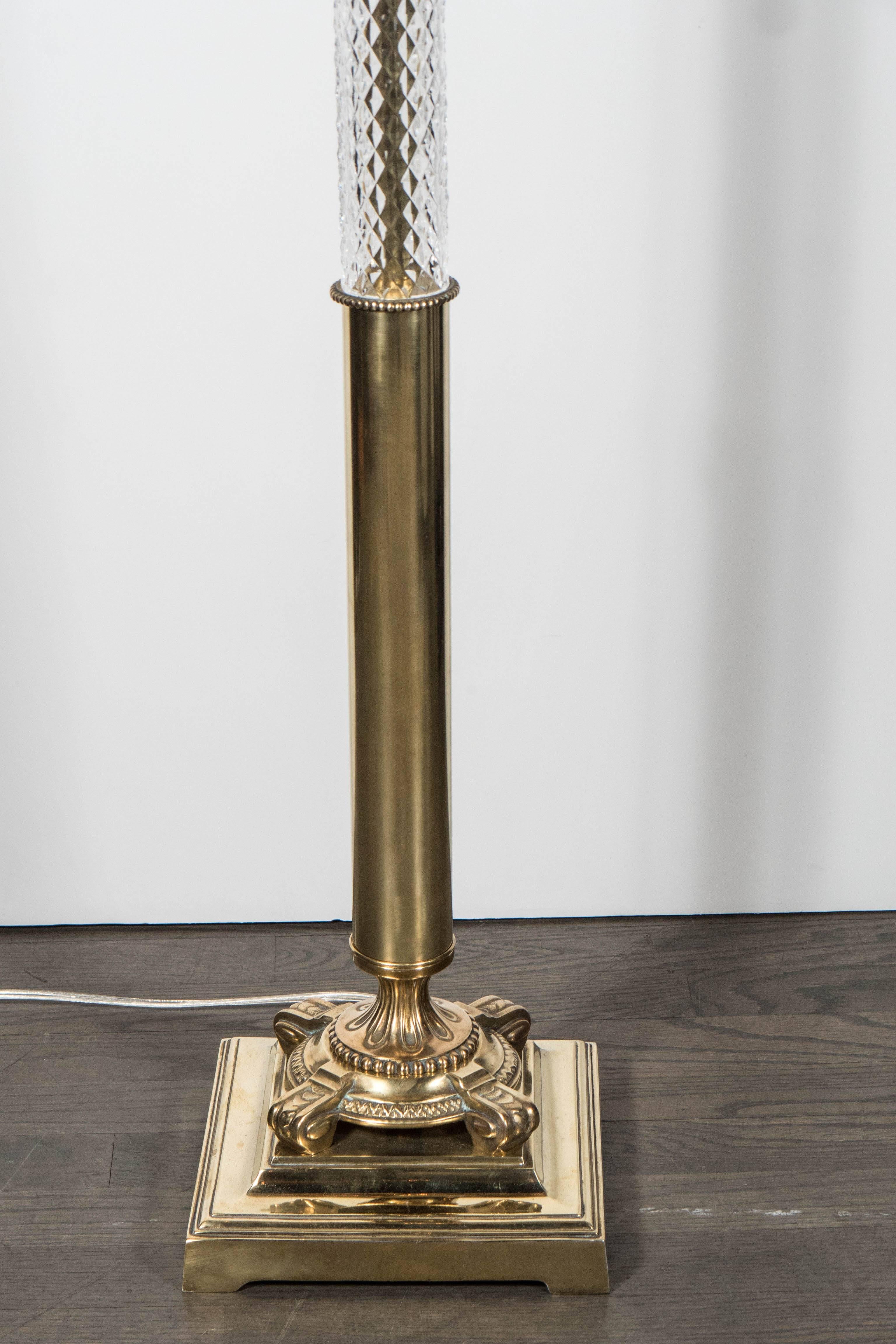 This stunning Art Deco floor lamp consists of a square brass base with elaborate fluted and beaded detailing throughout, it has three segments of textured glass separated by a brass beaded detail, at the top of the stem is a brass urn form detail.
