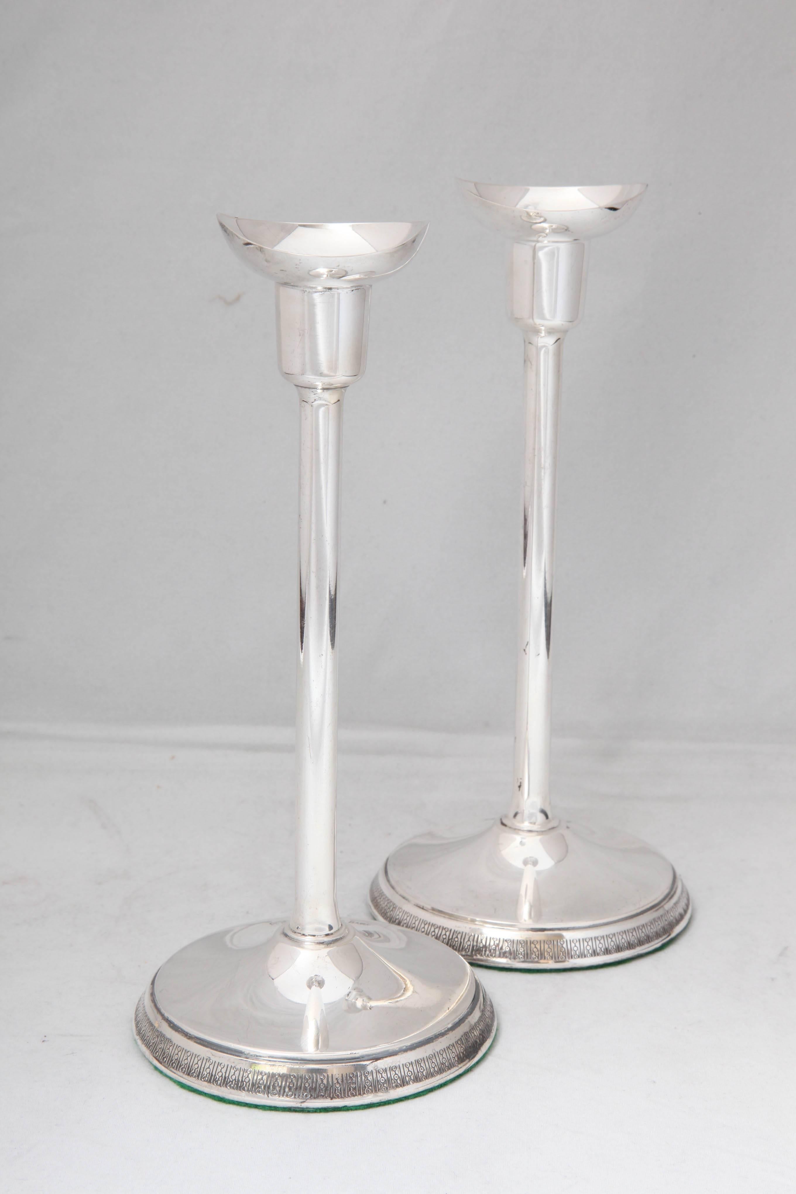 Pair of sterling silver, Mid-Century Modern candlesticks, Stockholm, Sweden, 1974, Ainar Axelsson, maker. Interesting etched design on border of base of both candlesticks. Each is 7 3/4