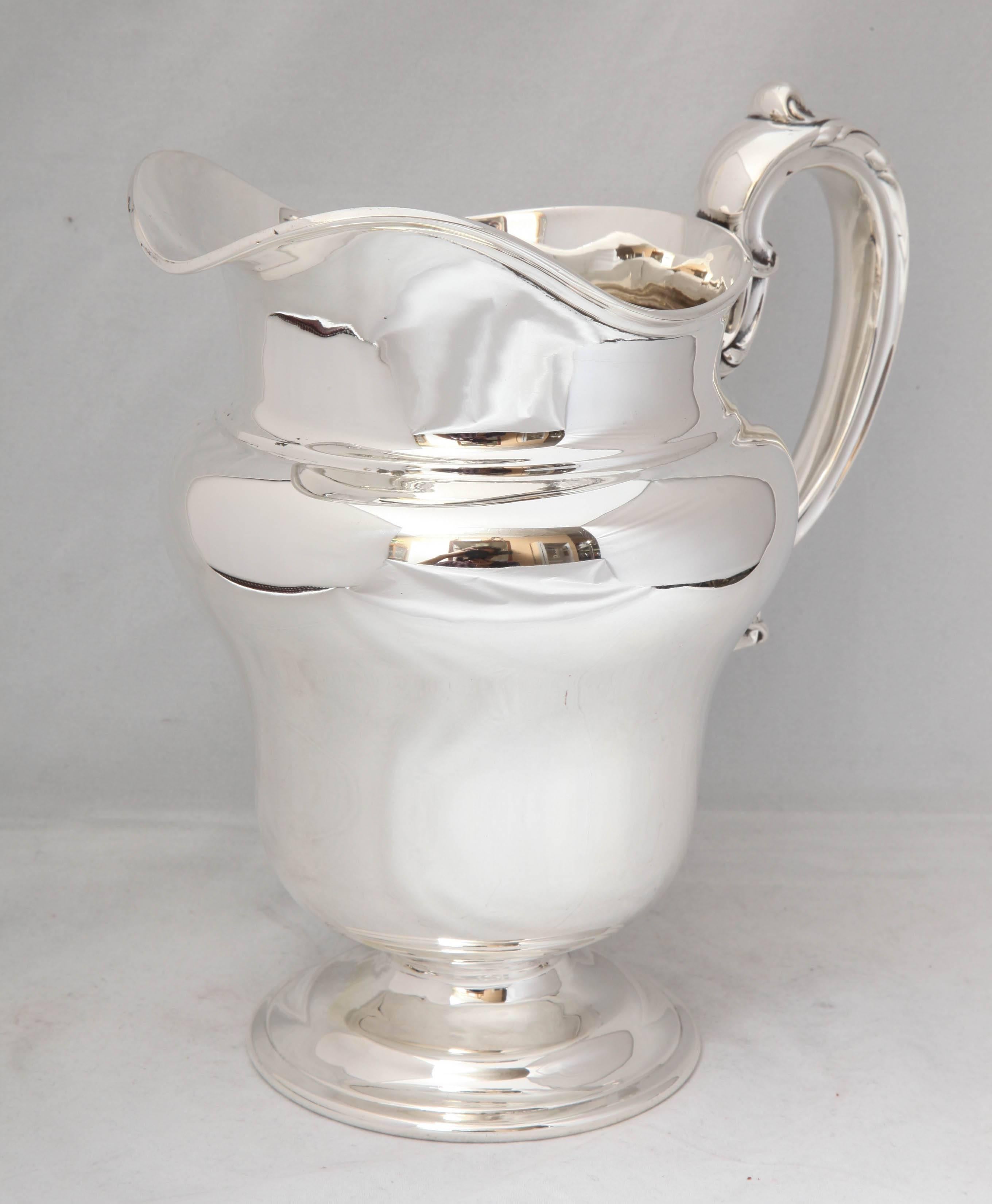 Graceful, Art Nouveau, sterling silver water pitcher on baluster base, The Frank M. Whiting &  Co., No. Attleboro, Mass., circa 1895. Holds 3 3/4 pints of liquid. 8 3/4