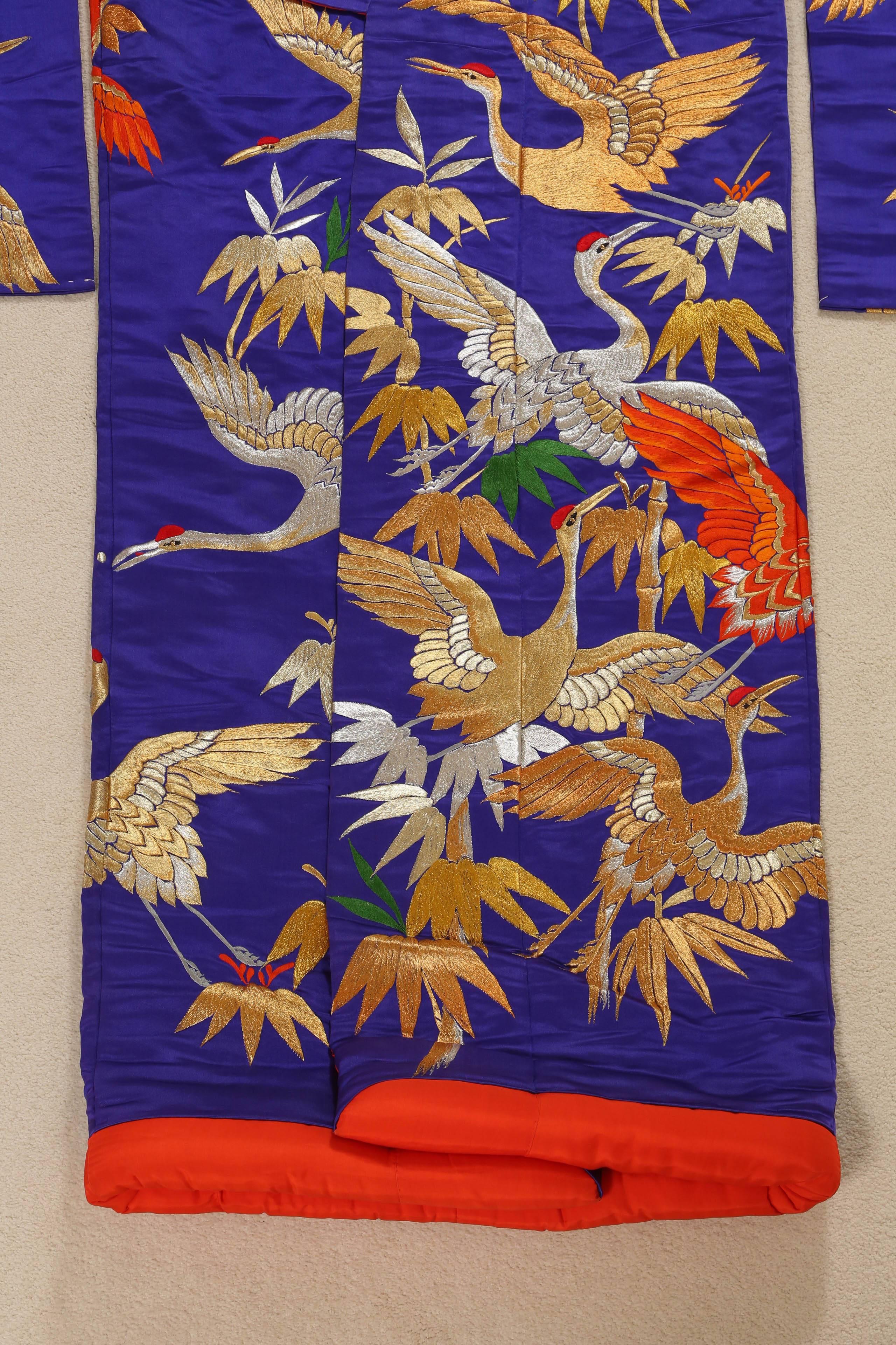 A vintage mid-century collectable Japanese ceremonial kimono, 
Fabulous Museum quality ceremonial piece in pure purple silk with intricate detailed hand-embroidery throughout accented with floral gold lame threads work that depicts, cranes and