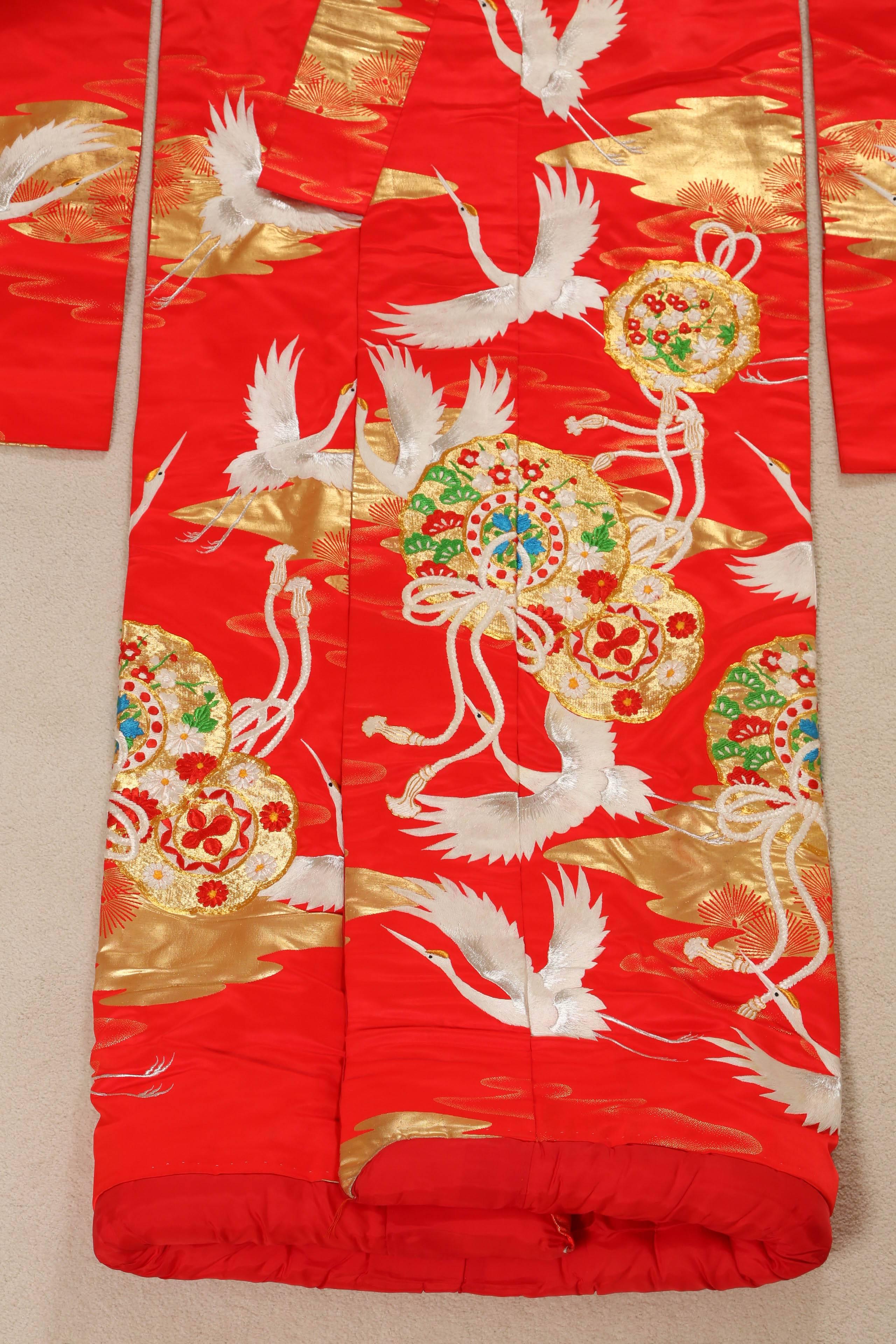 A mid -century vintage red silk Japanese ceremonial kimono.
Circa 1950.
 A great piece of textile art in splendid colors. Silk with red cotton inner layer, it features intricate embroidery work of cranes and flowers a traditional and stylized