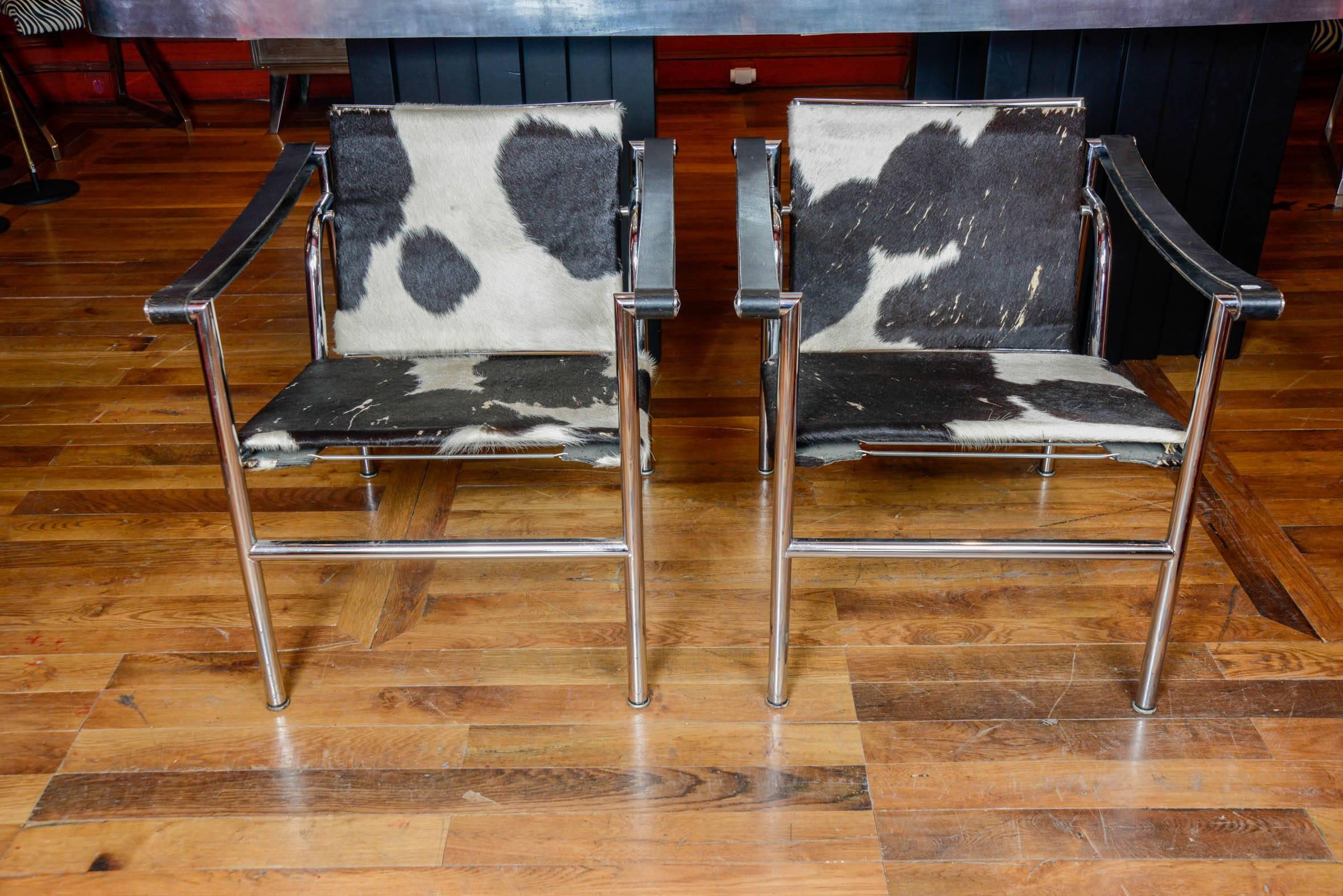 This pair of armchairs is marked Le Corbusier LC1 4854, pony skin and black leather