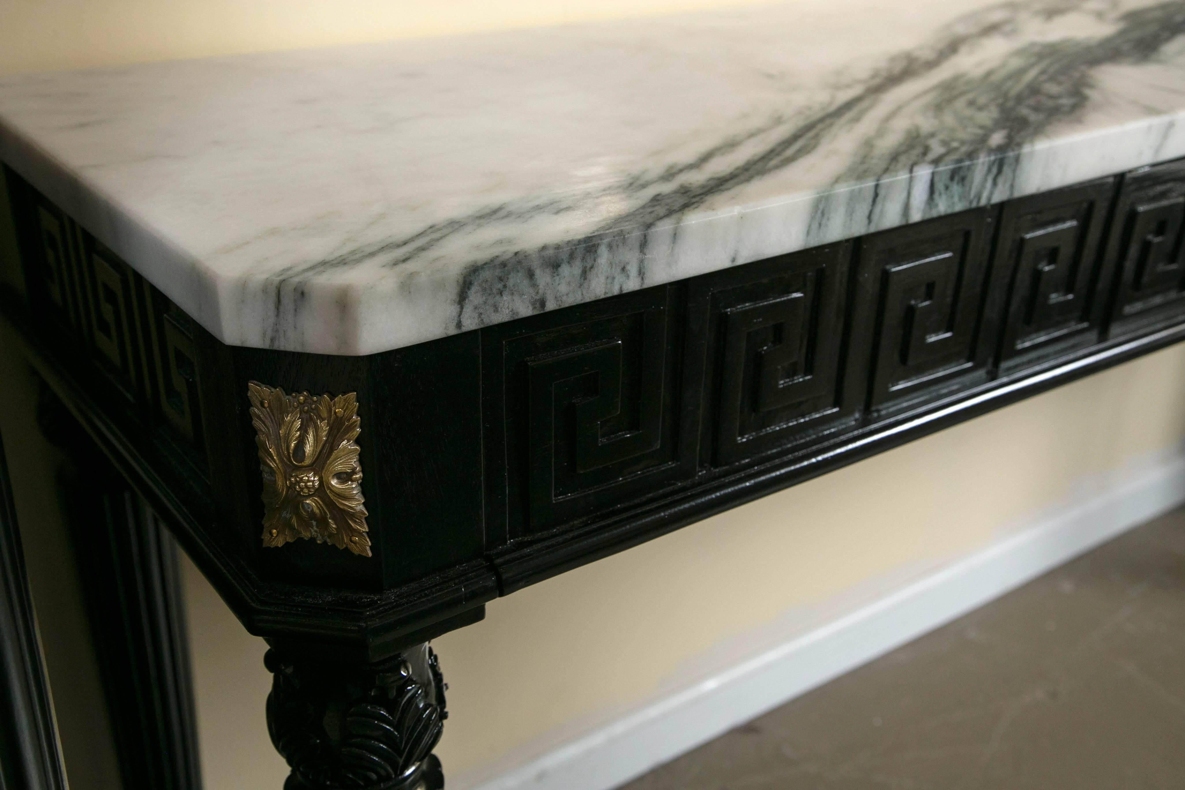 This Maison Jansen attributed Louis XVI style, ebonized marble-top, Greek key console is an fine example of this highly sought after designer. Two pull-out drawers for storage of keys or mail etc. The fabulous marble-top has beautiful coloring of