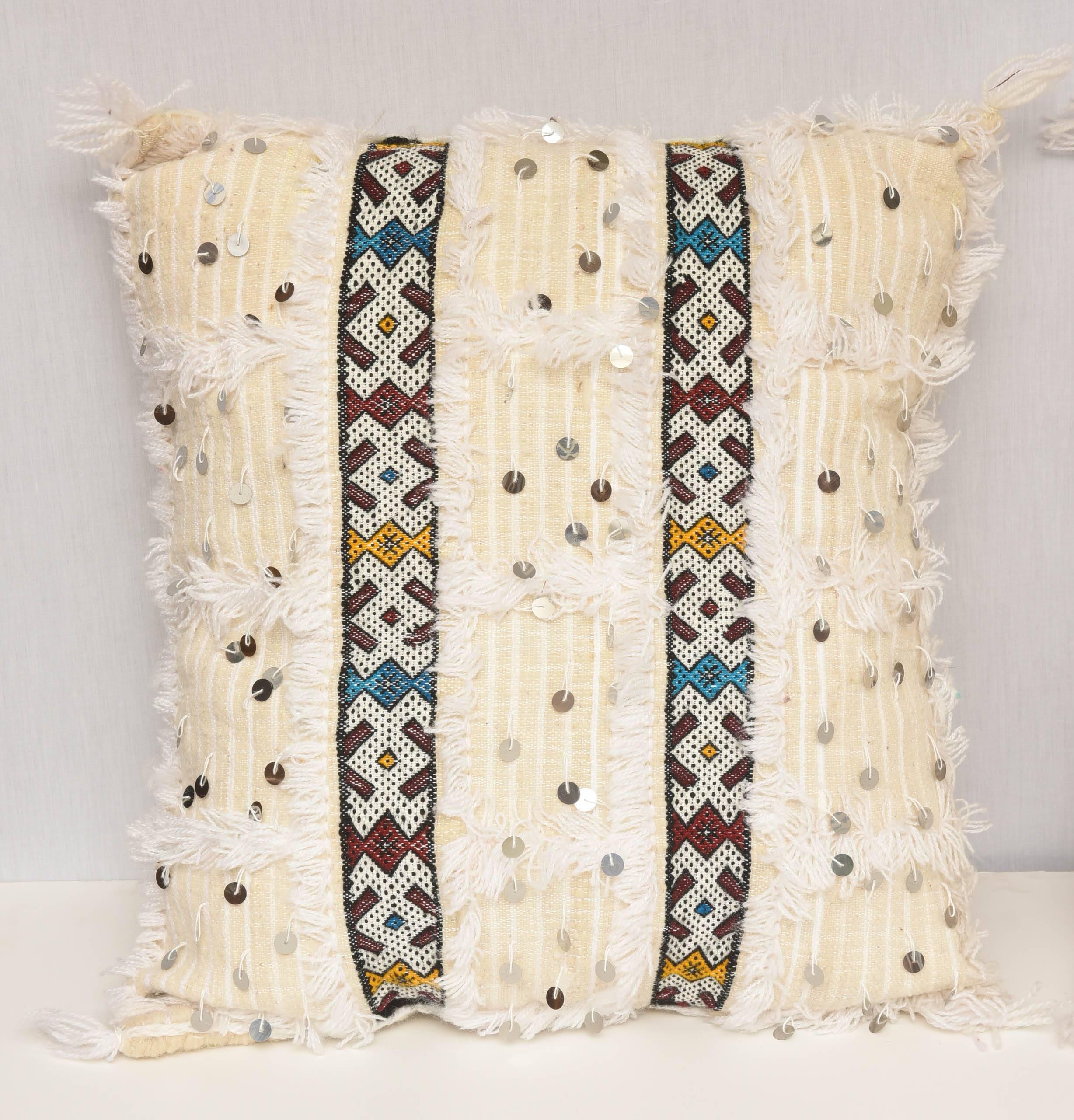 Two pairs of white Moroccan cotton pillows with great colors and details.
