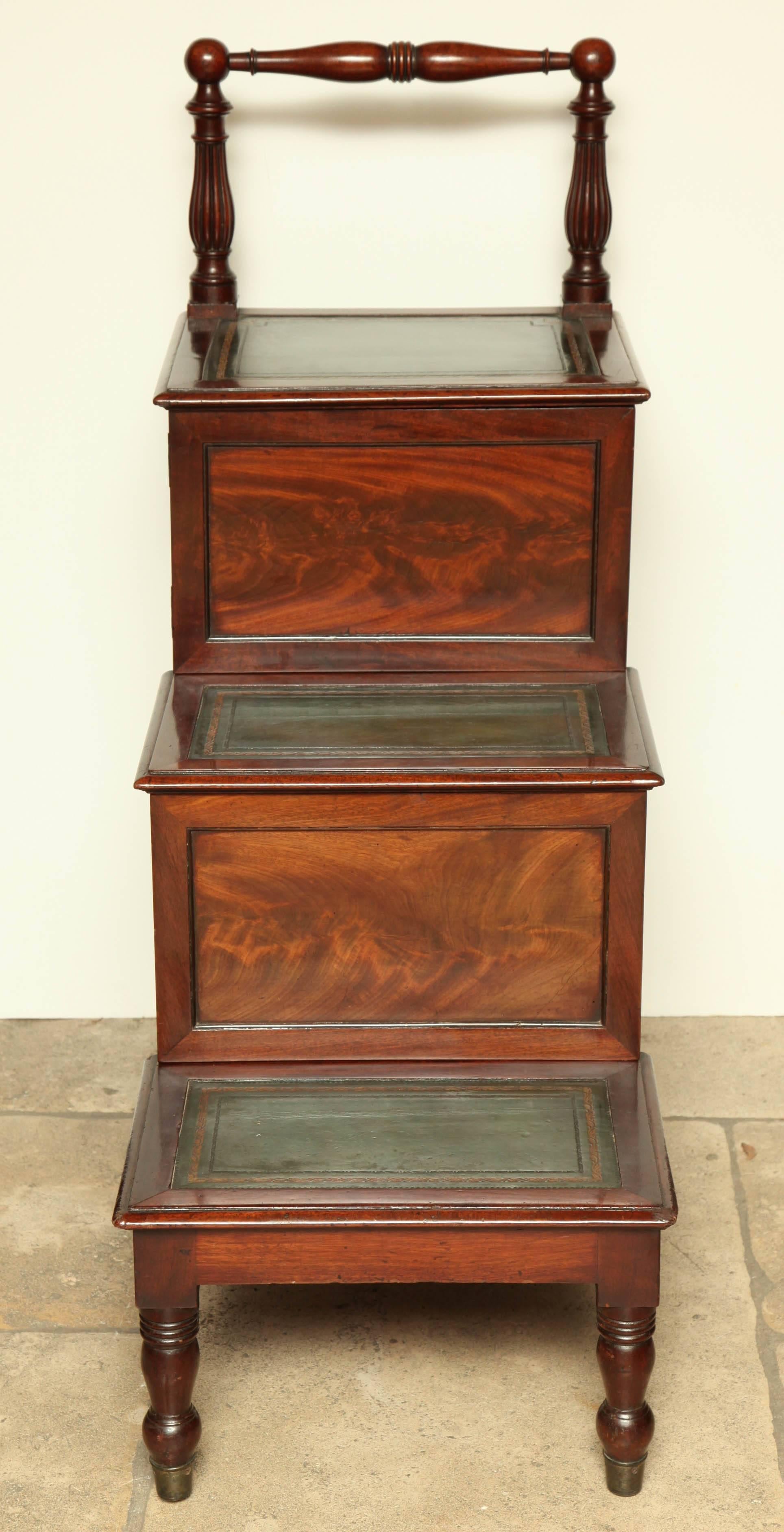 Set of Regency Mahogany library steps with gold tooled, green leather surfaces and unusual turned gallery handle.