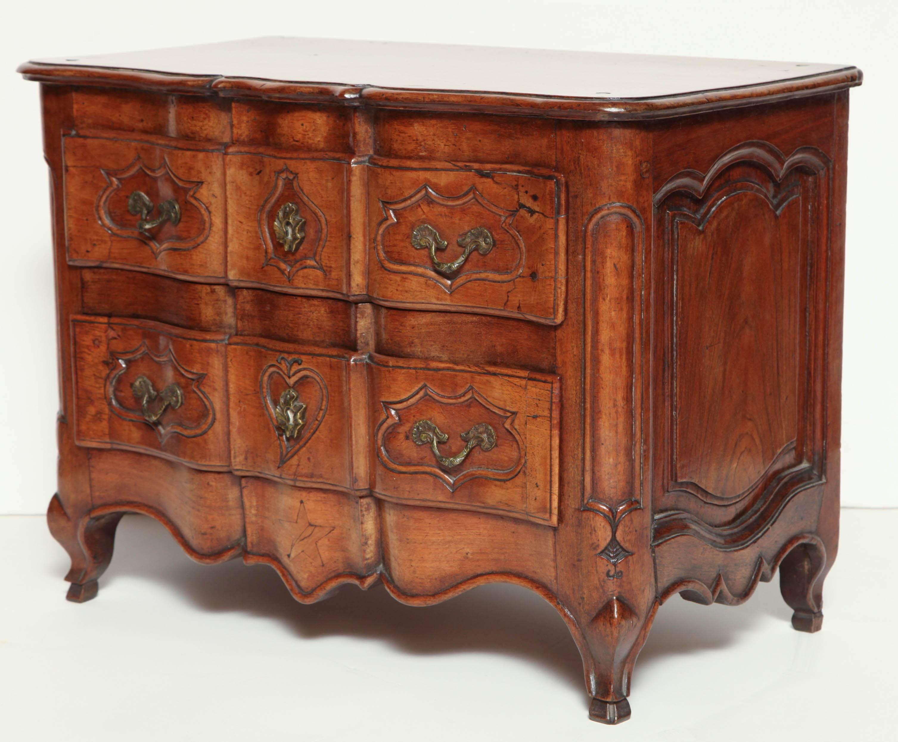 A fine French Louis XV Provincial walnut miniature commode with serpentine front and paneled side on carved hoof feet.
 