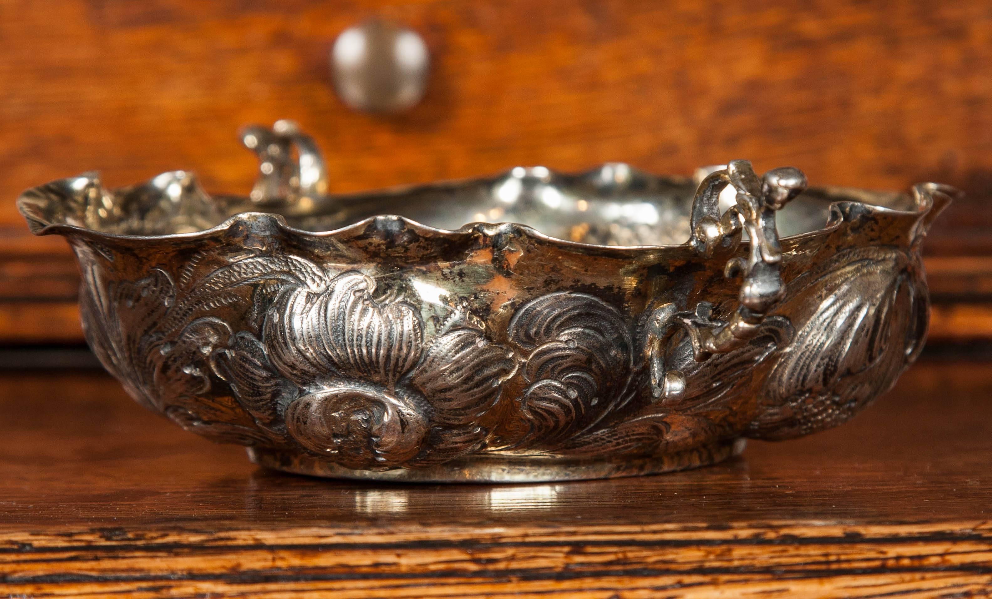 A charming late 17th / early 18th century Nuremberg silver and parcel-gilt Bon Bon dish in fine condition.
The centre pounced with stylised foliate designs within a deeply lobed and repoussee flower head and leaf border and having two cast openwork