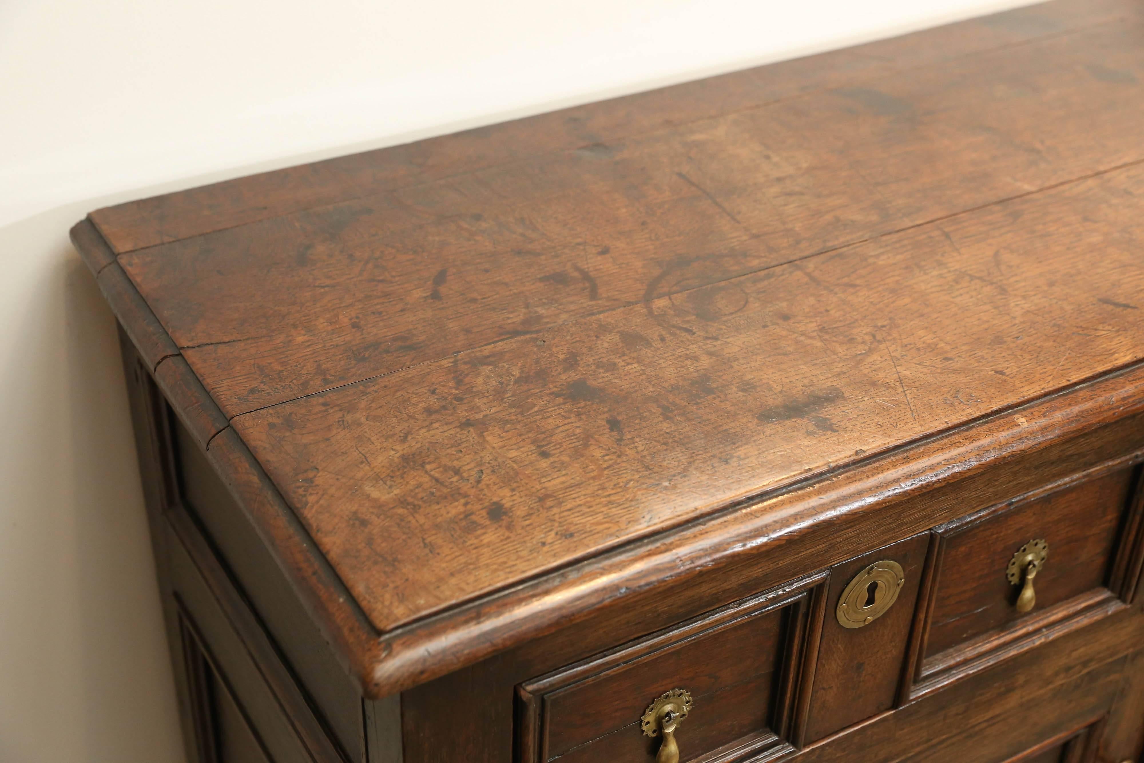 18th century Jacobean Welsh dresser base with three drawers and a pair of doors below. Beautiful patina and original hardware.