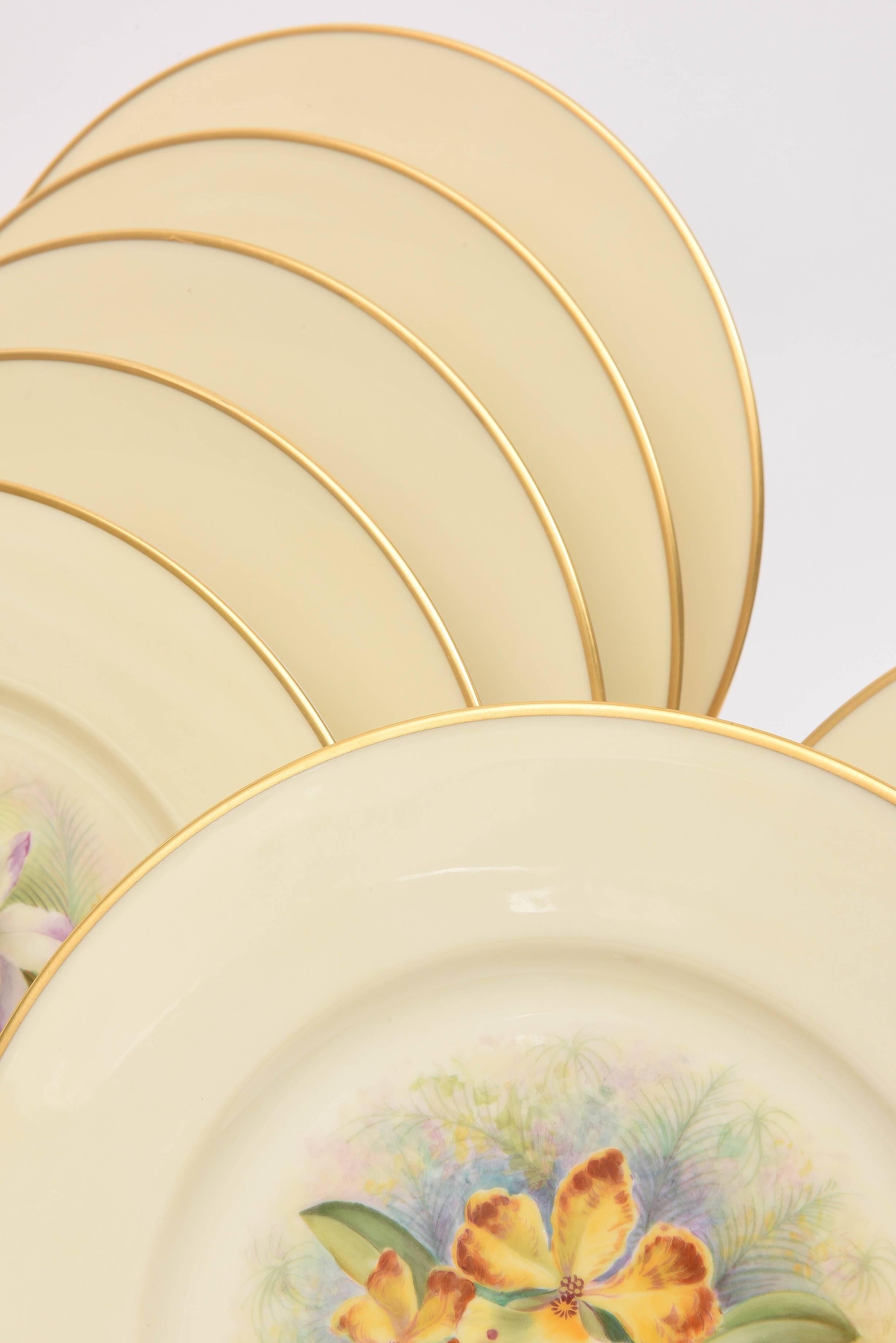 A stunningly vibrant set of hand painted and realistic orchid plates (12) by one of Lenox's great botanical artists. Completely signed and hallmarked and were once exhibited in the Lenox museum. Trimmed in 24-karat gold and painted on a soft cream