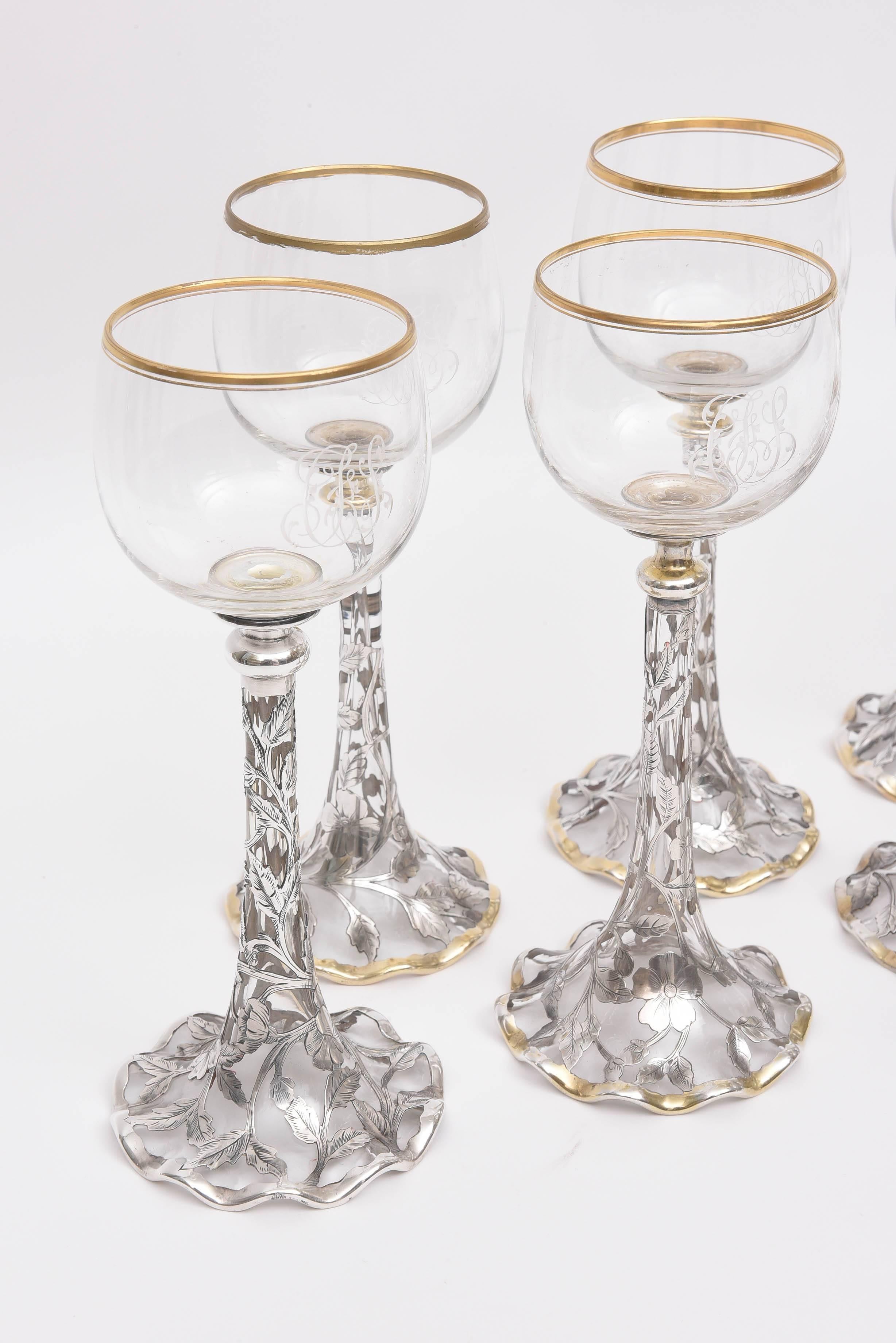 A delightful and elegant set of wine goblets featuring blown crystal bowls and an intricate sterling overlay design by Gorham. Hallmarked. Trumpet shaped stem with a very pretty ruffled base. Trimmed in 24-karat gold. An unique set of and