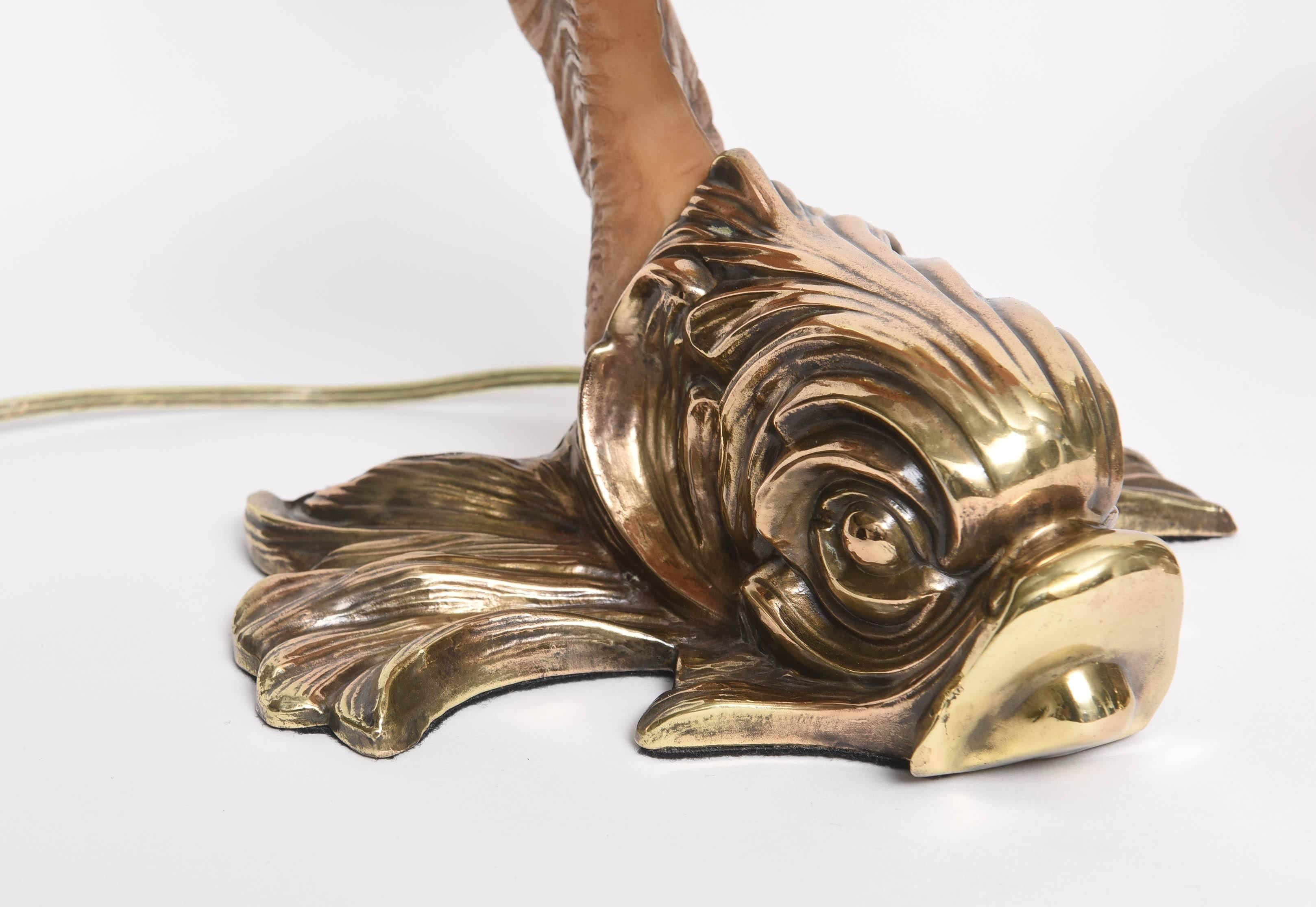 This pair of Hollywood-Regency/Rococo style table lamps were created by the iconic firm Chapman Manufacturing in the 1980s. The grotto inspired dolphins with upturned Horn-bodies (in cast-resin) definitely evoke emotions of the exotic and whimsy.