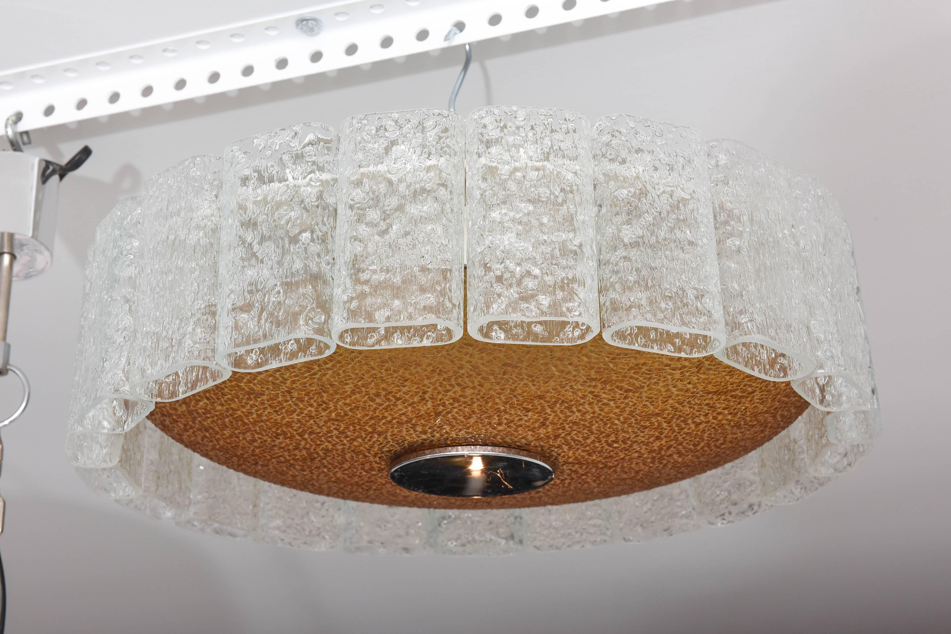 This amazing fixture was created by the iconic firm Doria Leuchten in the 1960s.  The circular central disc is in a amber/gold color eisglas with a polished chrome fitting. There are twenty-one molded prisms in clear eisglas.

Note:  The piece