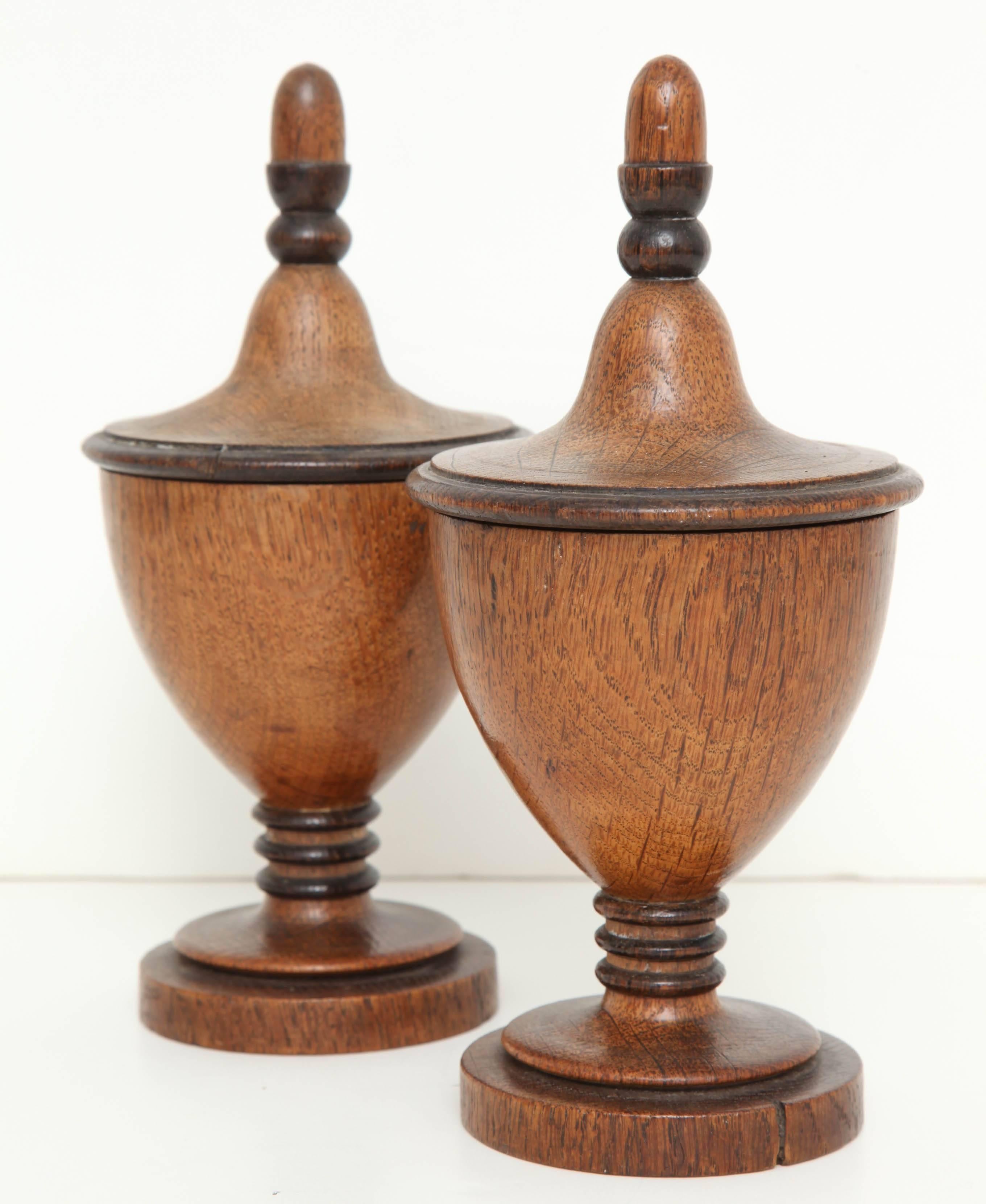 A pair of early 19th century English neoclassical turned oak and ebonized tureen lidded urns circa 1820