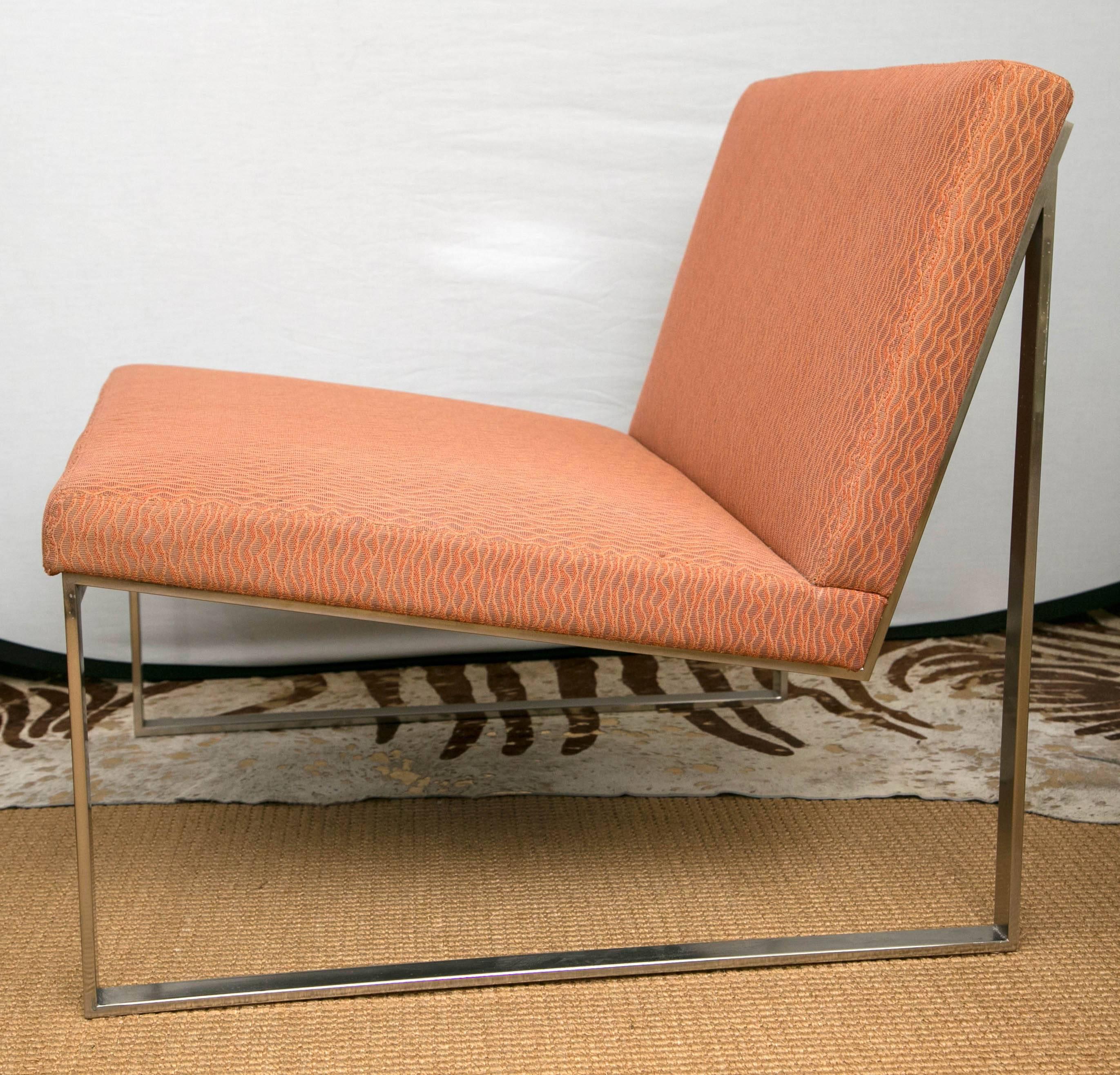 A pair of lounge chairs designed by Fabien Baron for Bernhardt design. The chairs are a brushed nickel open frame design. Currently upholstered with a custom light orange fabric.