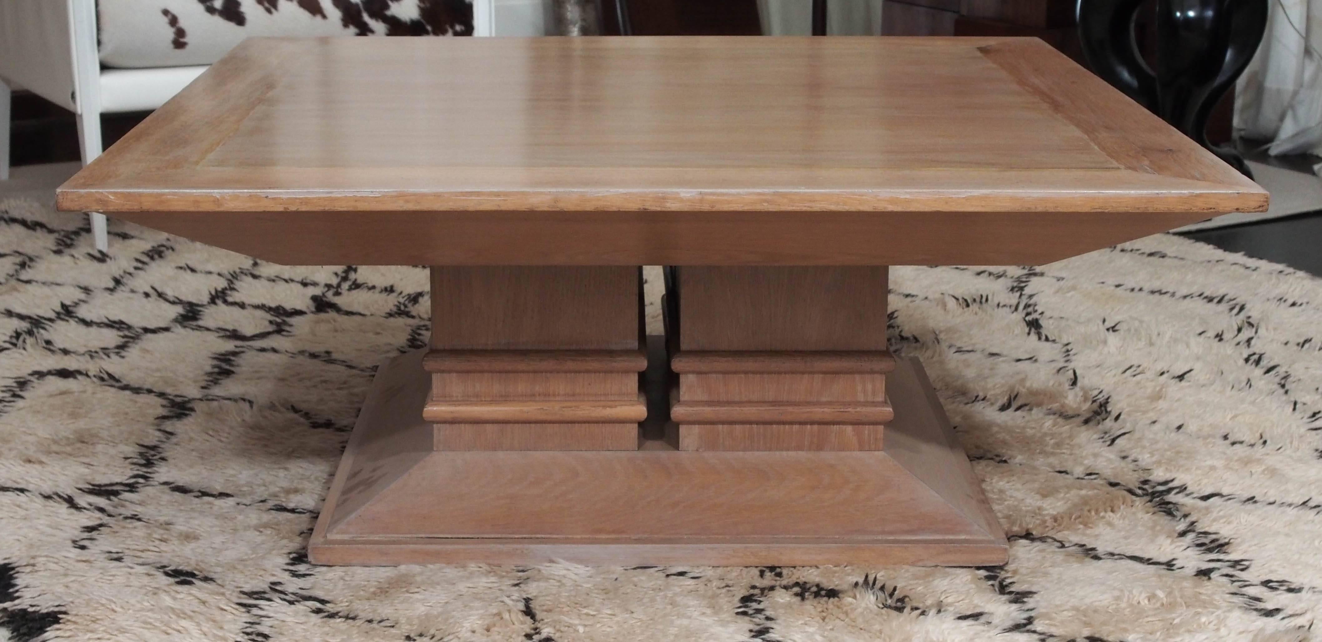 Large oak coffee table on four square columns with twin half-round banding; tapered plinth; two tables available.