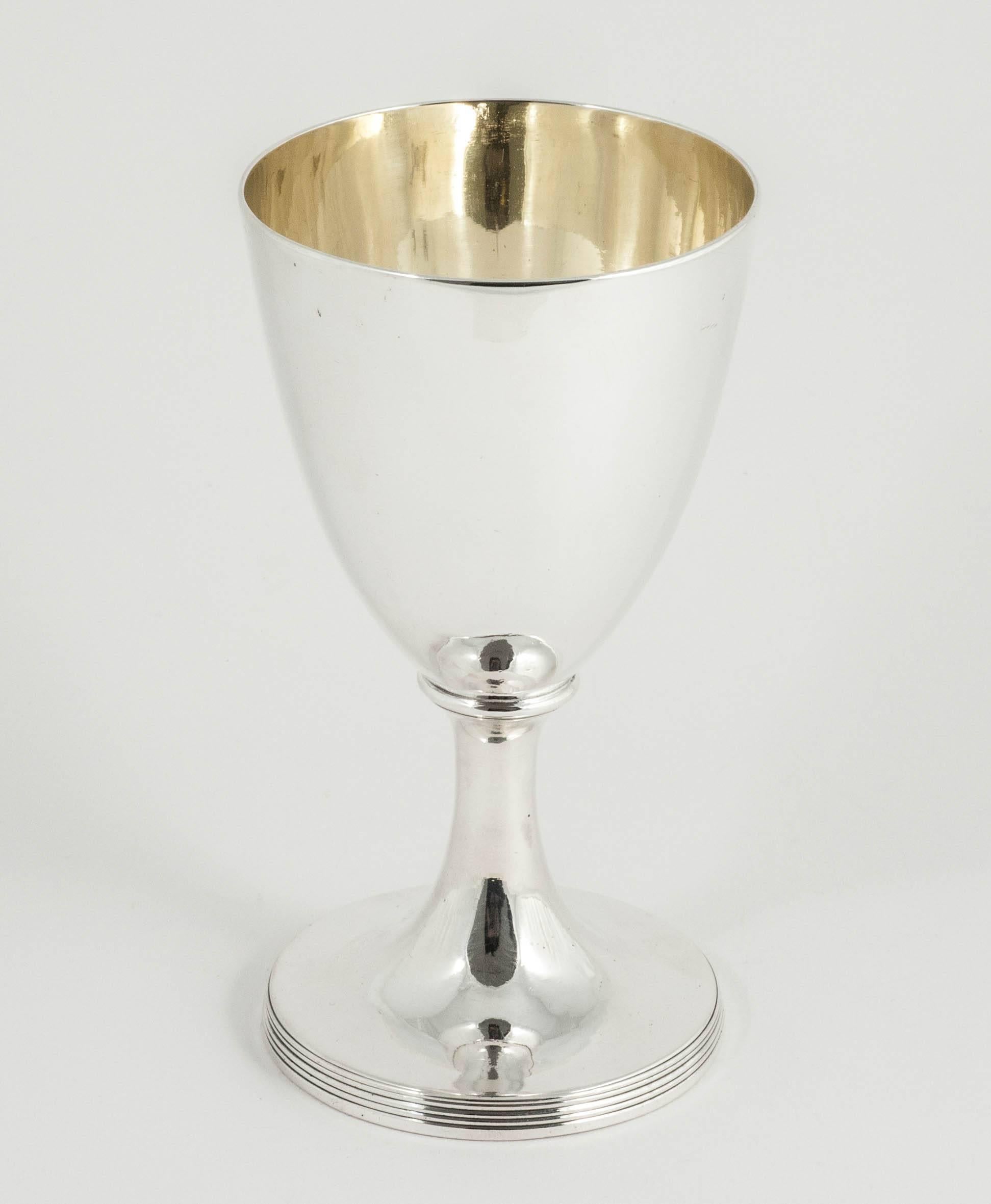An elegant pair of Georgian sterling silver goblets of simple vase shape with spreading foot and a subtle thread pattern at the base. This style is a classic George III design and these examples are in wonderful condition with gold-plated interiors.