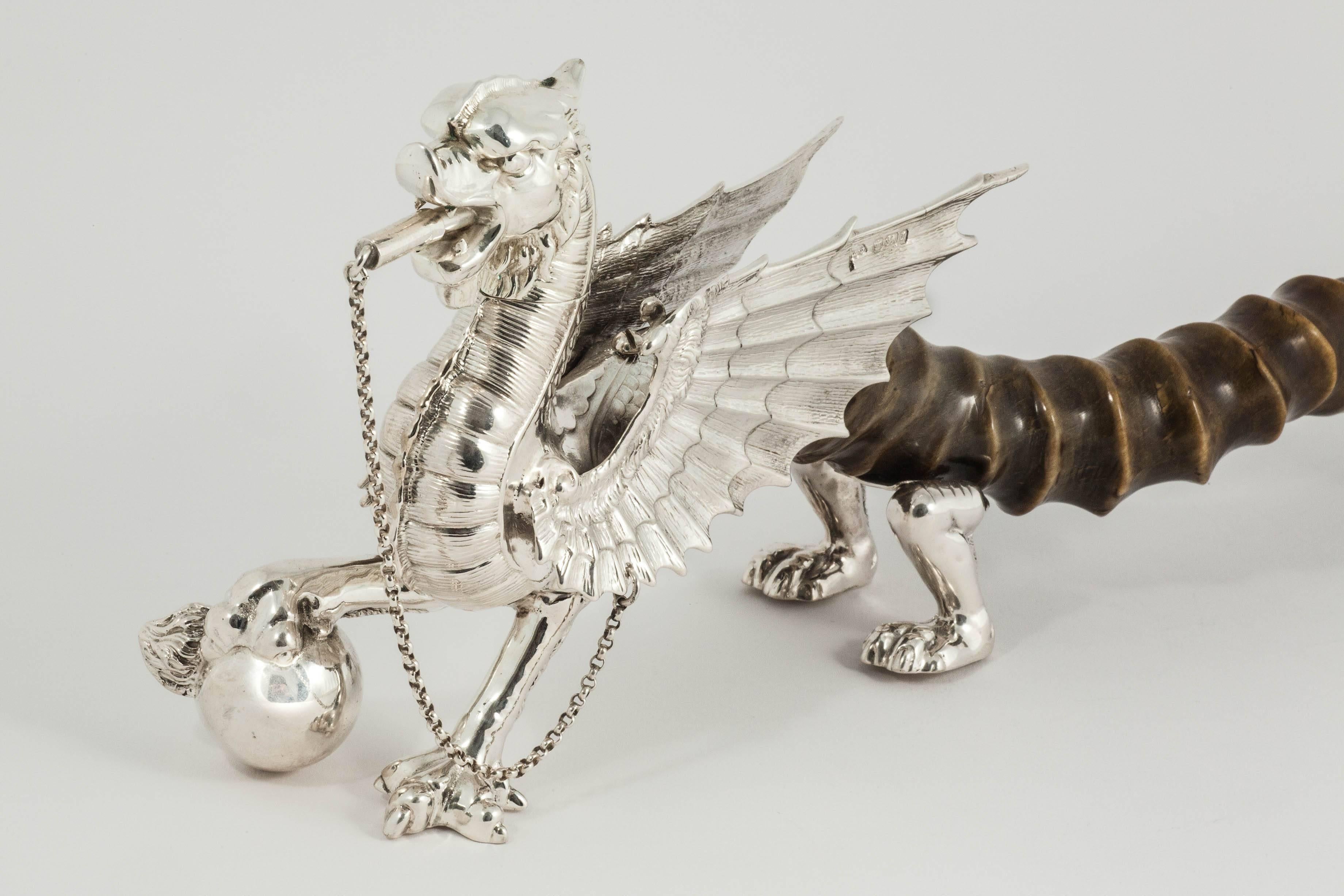 A very rare antique silver table lighter in the form of a dragon with antelope horn for its body and tail. This style of cigar lighter, typically made for a military mess table, was almost always made in silver-plate and it is incredibly rare to