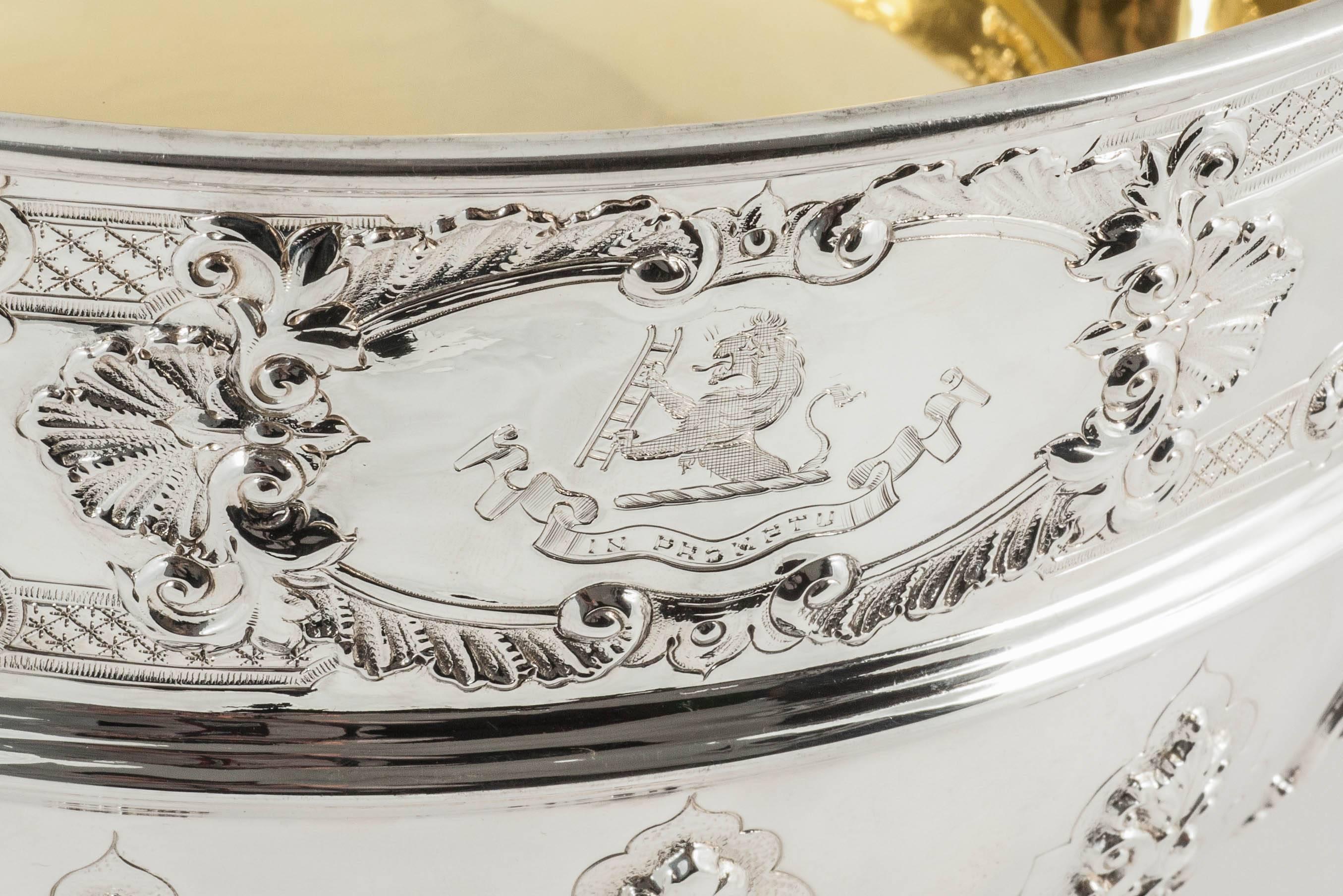 A heavy quality sterling silver Victorian rose bowl or punch bowl with gold plated interior. This impressive piece, in the George II style, has a band of hand-chased lattice, leaf and shell designs above the central girdle and cast and applied strap