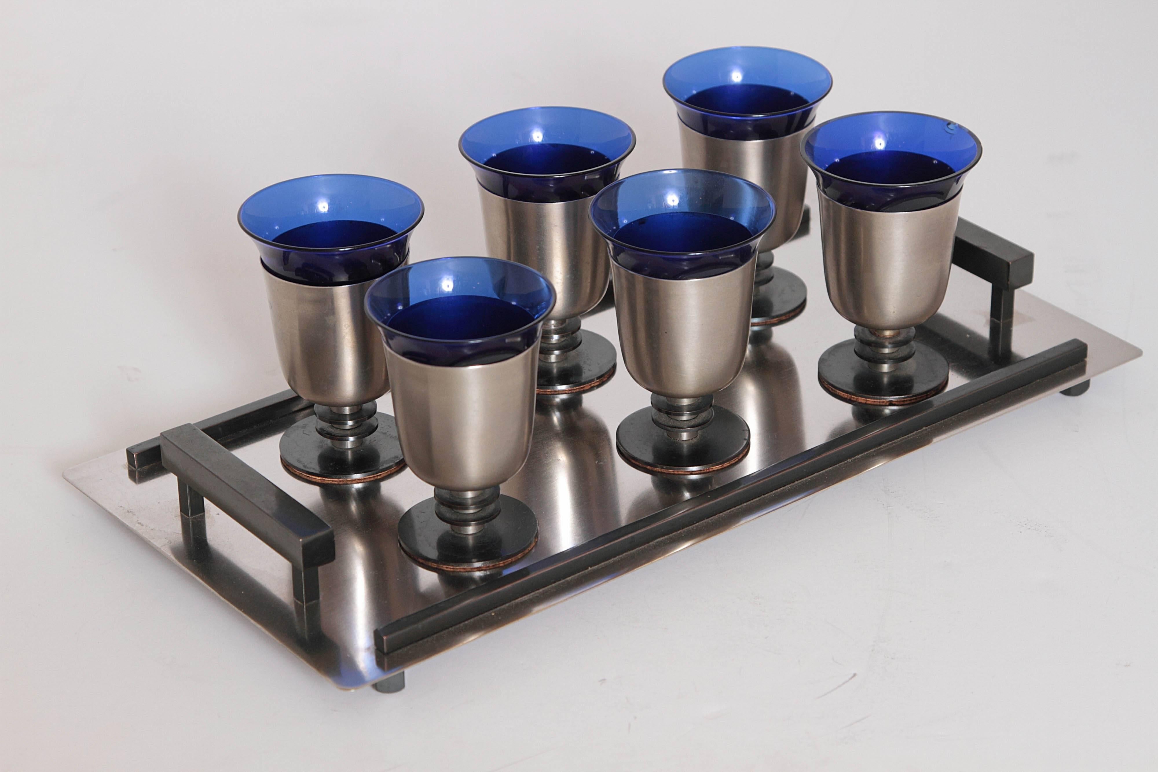 This set is typically seen in all polished chrome, occasionally copper.
Here is the original rare brushed chrome or nickel/black anodized version.
Cobalt inserts perfect, original cork base liners, original black accent.
To our knowledge, not