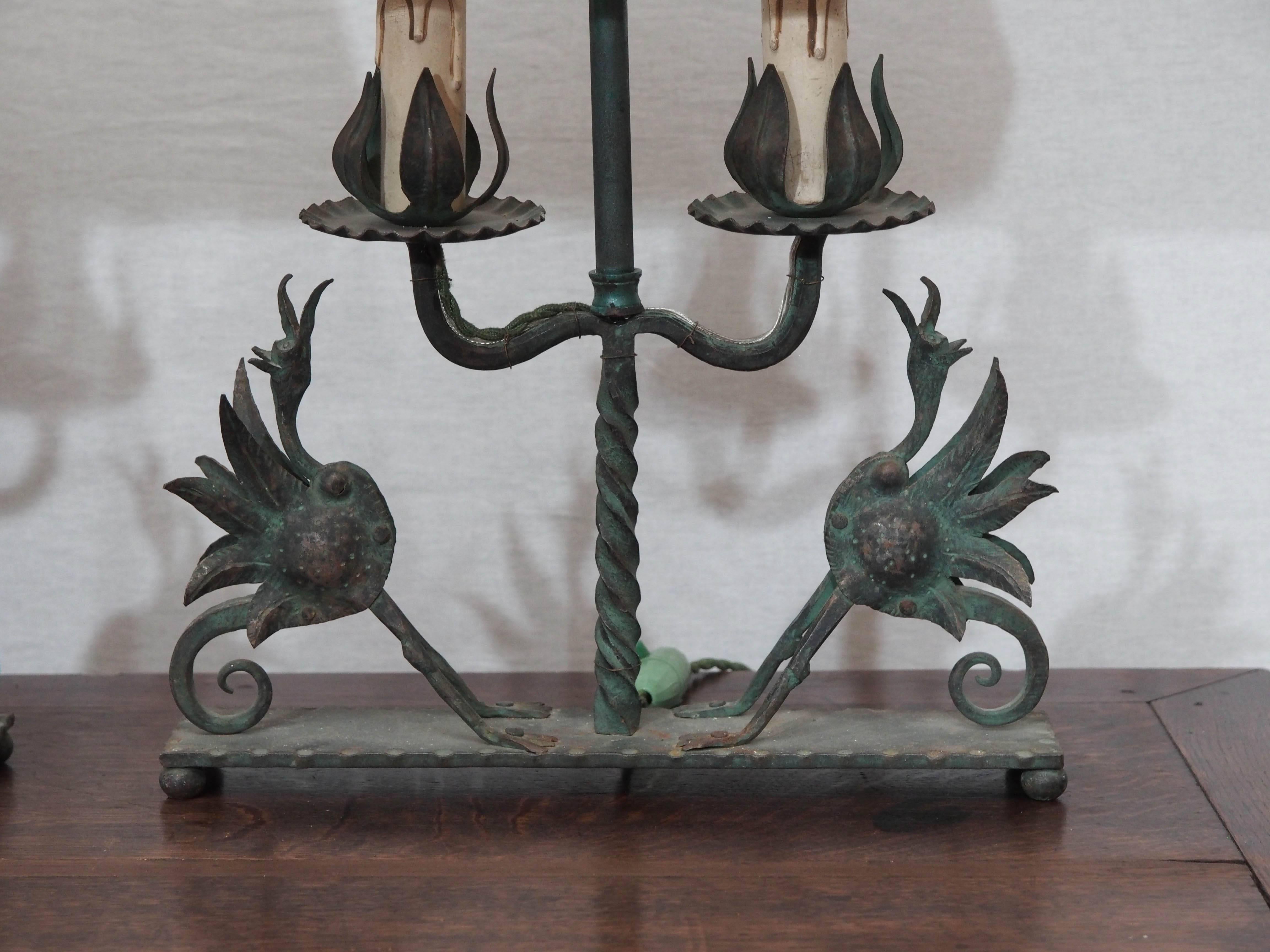 A pair of verdigris, hand-forged iron lamps, attributed to Michel Zadounaïsky, each having two lights over a pair of finely detailed birds. Recently wired to U.S. specifications, shades included.
