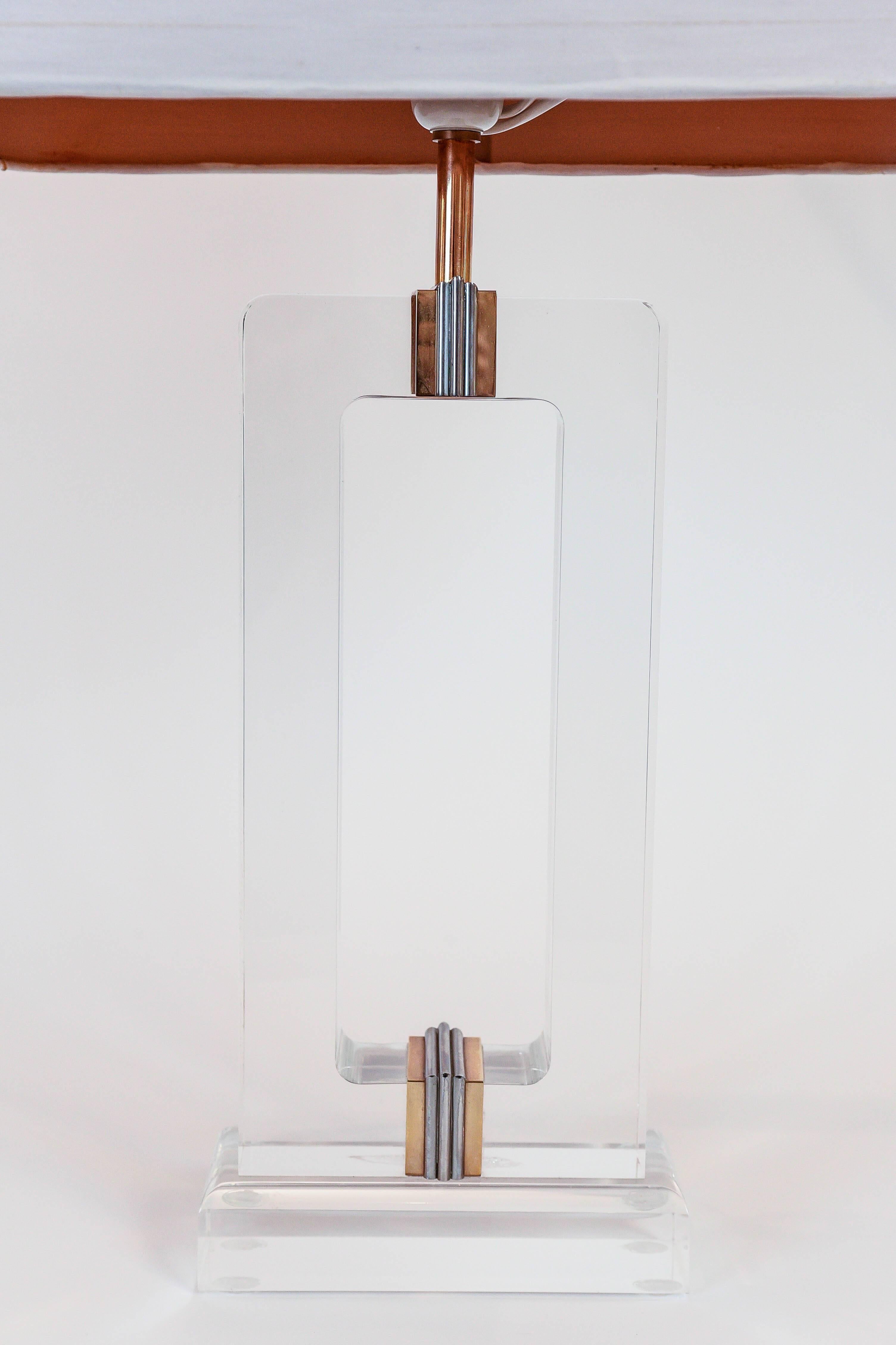 This suave acrylic lamp has a weighty and pleasing form, and is accented with
